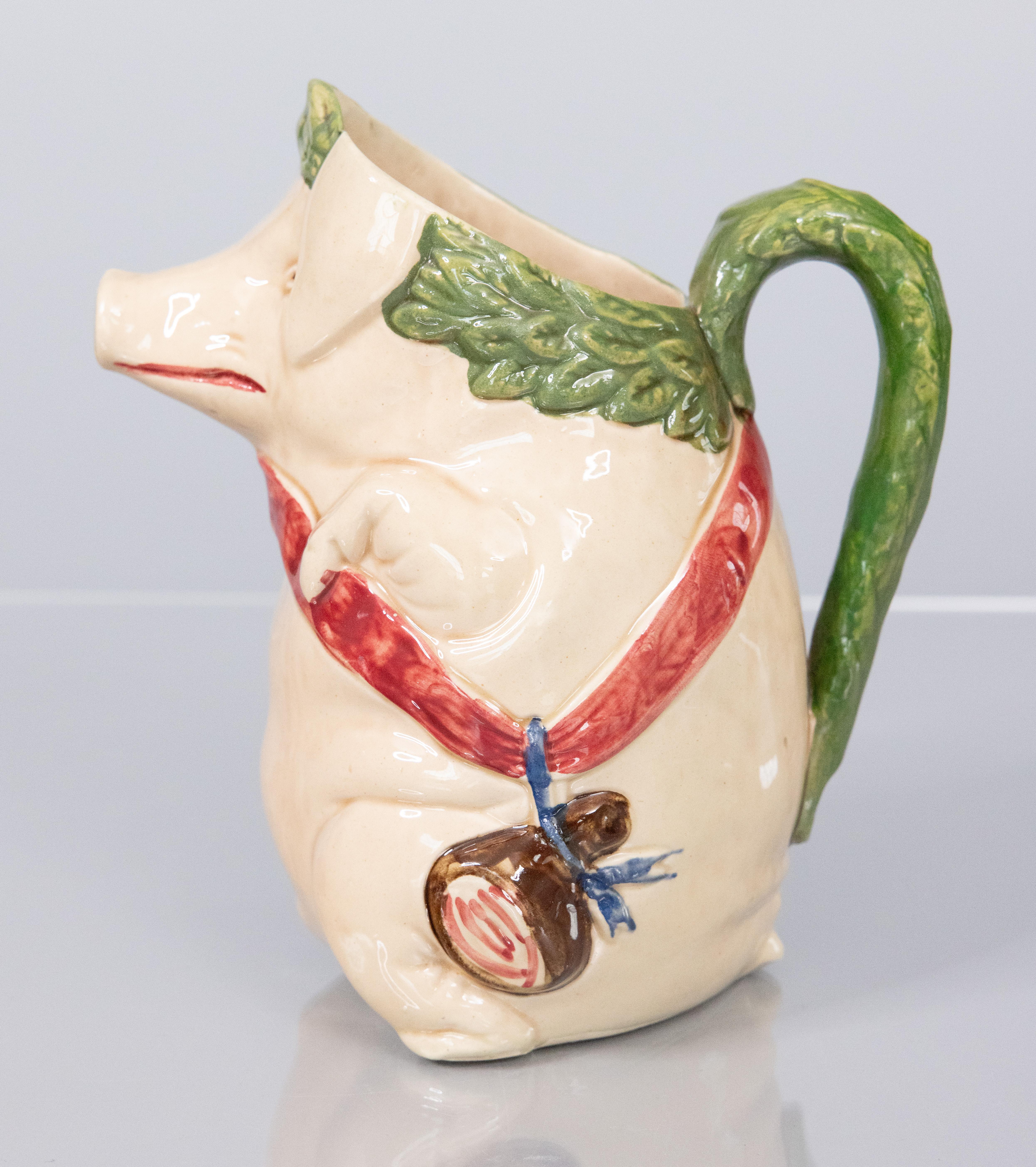 A charming French majolica barbotine pig pitcher by Orchies, circa 1880. Maker's mark on reverse. This highly collectible pitcher, titled 