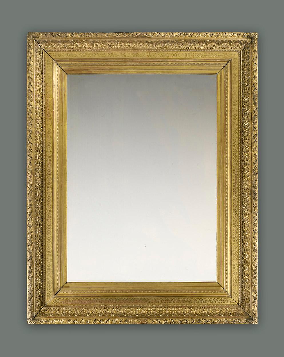 A very fine and rare 19th century French orientalist neoclassical salon frame. It has an entablature profile and the following ornament is applied in moulded Plaster of Paris: raie-de-coeur; frieze incised with burnished fretwork and foliage;