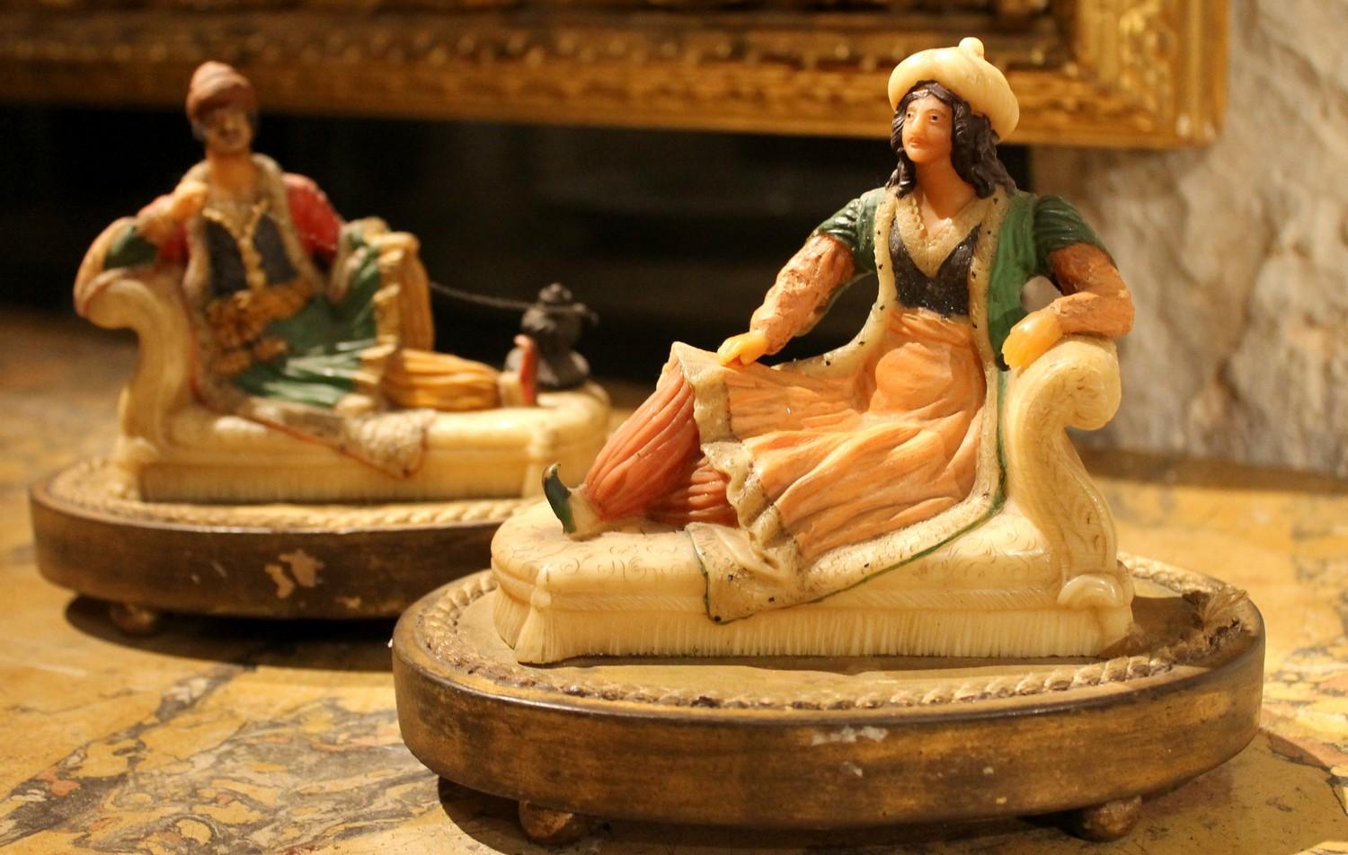 These unusual hand-sculpted polychrome wax figurines on giltwood base depicting two Arabs relaxing on a sofa perfectly captures late 19th century Europe's perspective and aesthetic fascination with Middle Eastern cultures.
These highly decorative