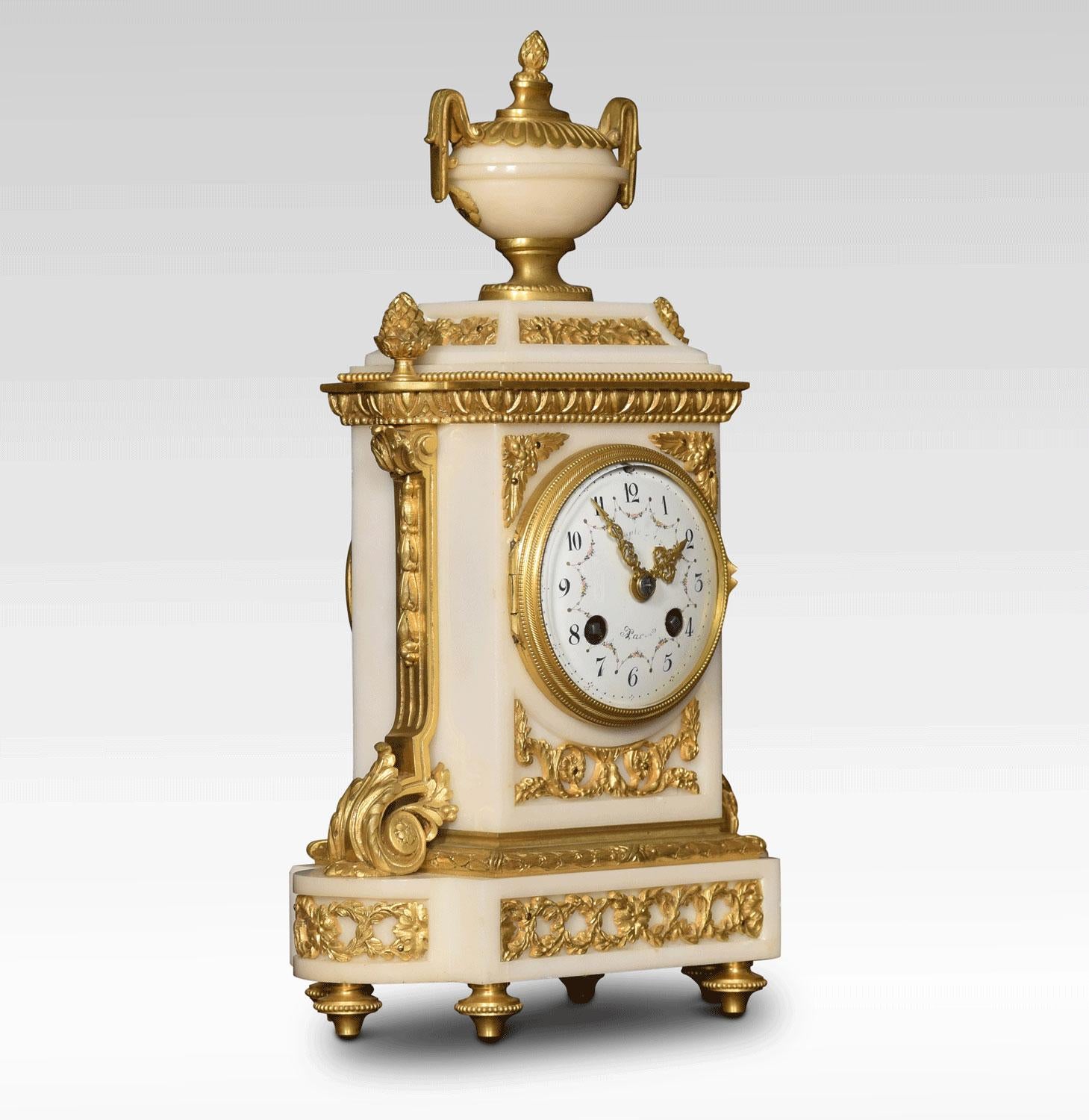 19th century French ormolu and white marble mantel clock, the white enamel dial with scrolling flowers and numerals inscribed Maple and co. The very high quality two-train movement striking on as bell. The clock case surmounted by a urn and flanked