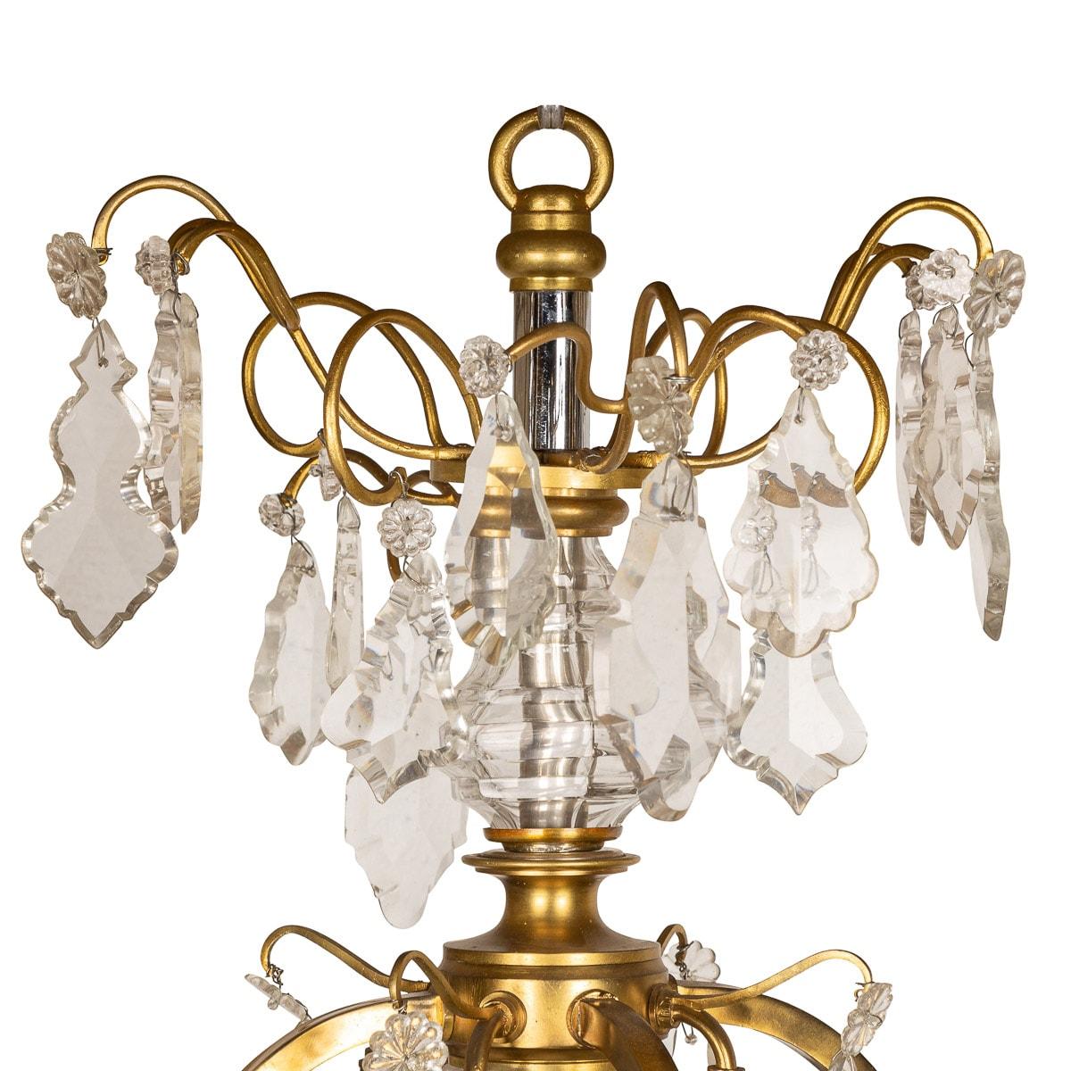 Antique 19th Century French very fine chandelier composed of ormolu bronze and cut crystal. Each crystal has been hand cut into lozenge shaped droplets with small flowers above and with a spherical faceted crystal ball underhanging. The chandelier