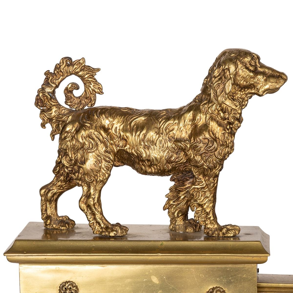 Antique 19th century French ormolu bronze fireplace chenets, decorated with two dogs facing each other standing on square plinths decorated with cast resets, joined together by a pierced floral grill.

CONDITION
In Good Condition, please refer to