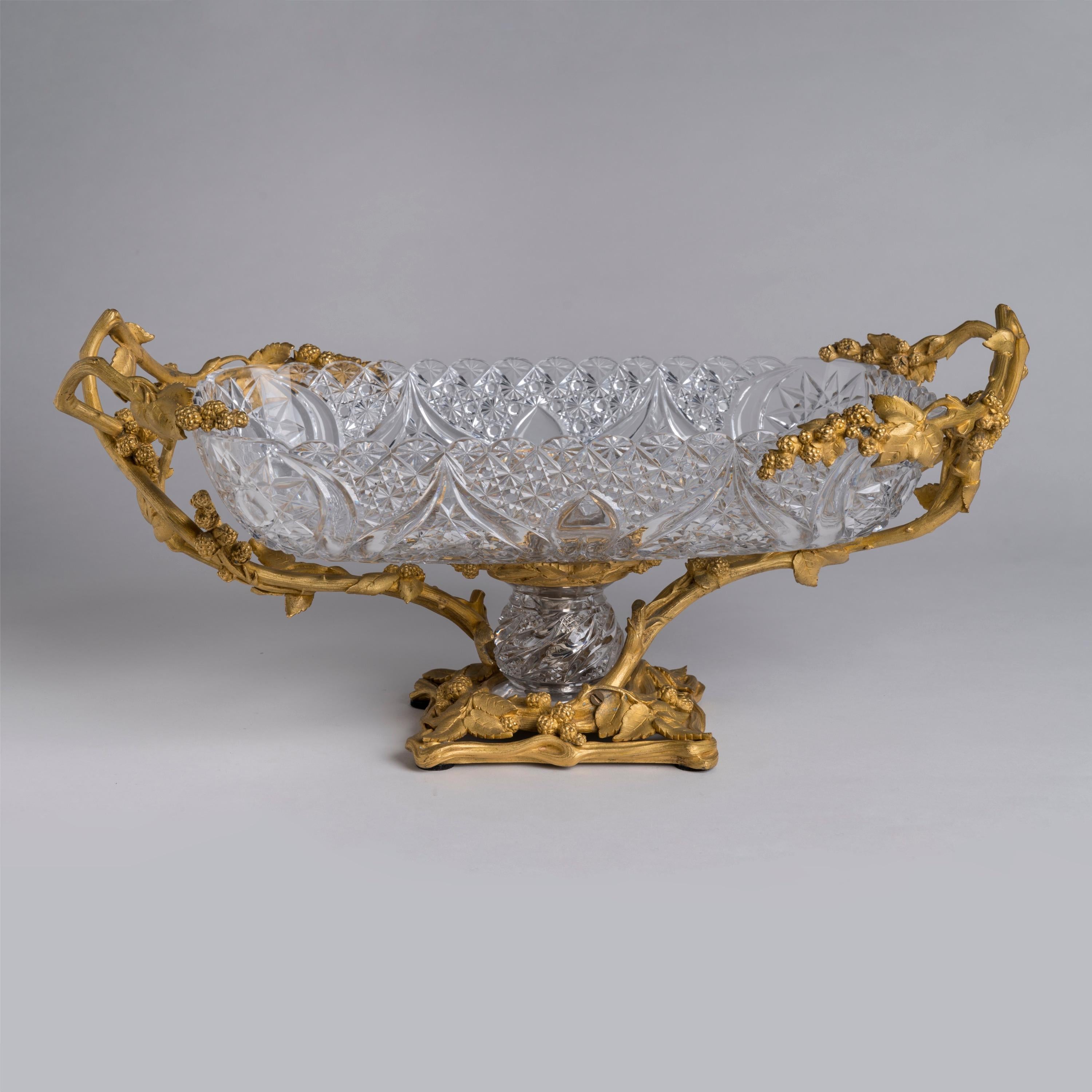 A Fine Ormolu-Mounted Cut Crystal Centrepiece
Firmly Attributed to Baccarat

A large and exceptional glass centrepiece set within a gilded bronze mounted frame, modelled in a naturalistic fashion with branches, leaves and trailing fruit, the