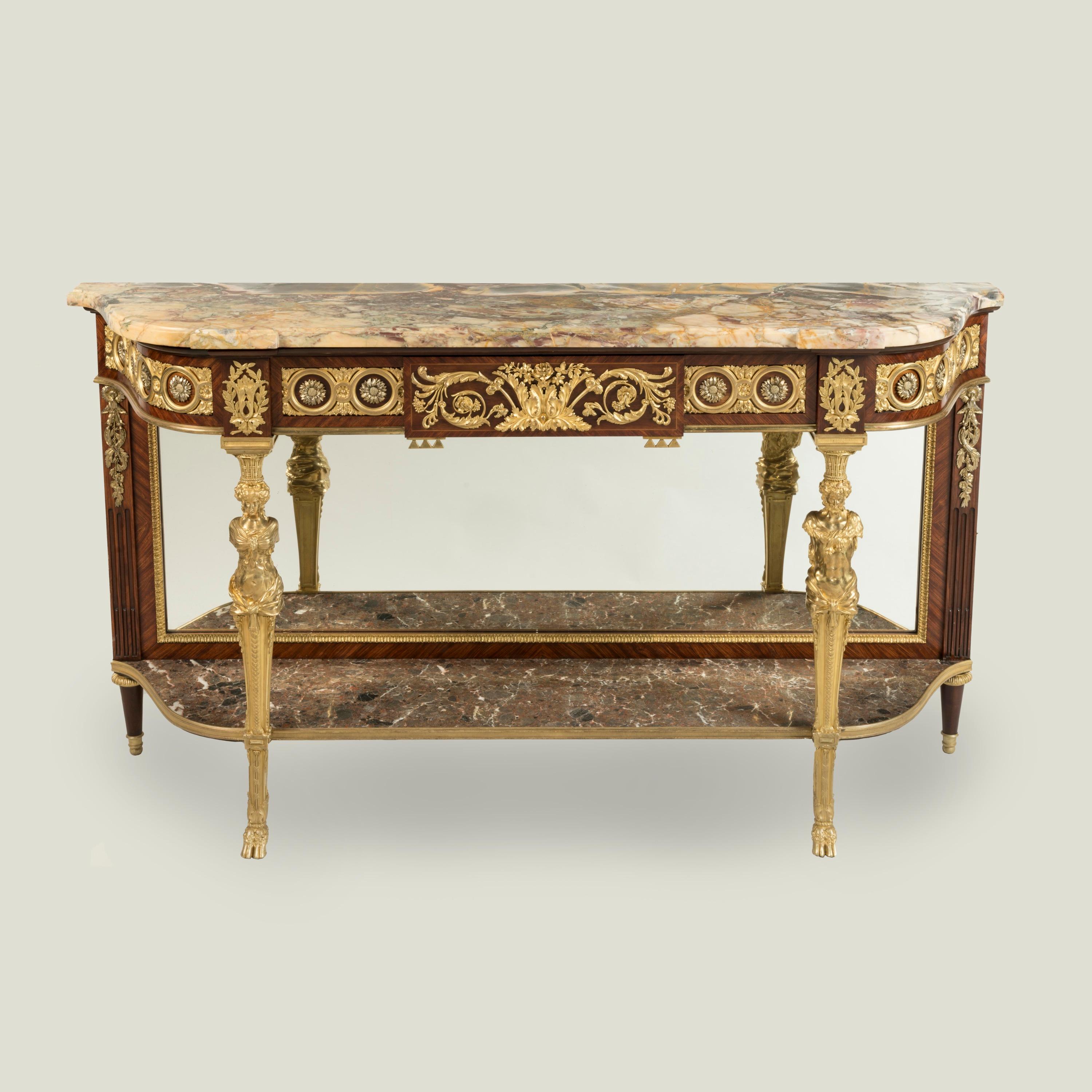 An Important Louis XVI Style Console Table

A superb example of Parisian craftsmanship, constructed from Kingwood and dressed with well-cast and hand-chased gilt and silvered bronze mounts; of arc-en-arbalète outline, with two ormolu figural front