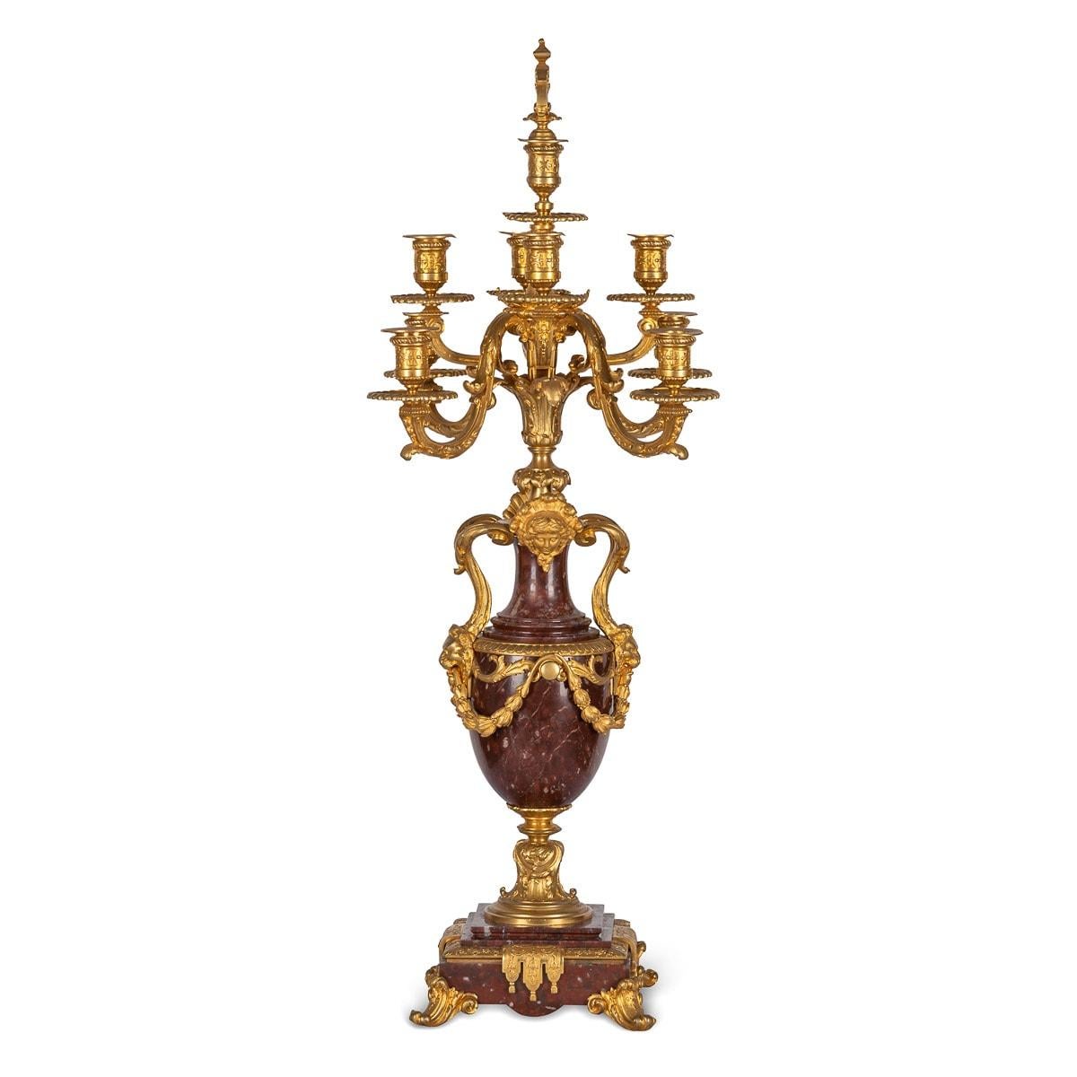 Antique 19th Century French pair of ormolu mounted on rouge griotte, nine light candelabra. Formerly with central vases, the scrolled candlearms issuing from the vase, on square bases and raised on scroll feet, body applied with lion and female