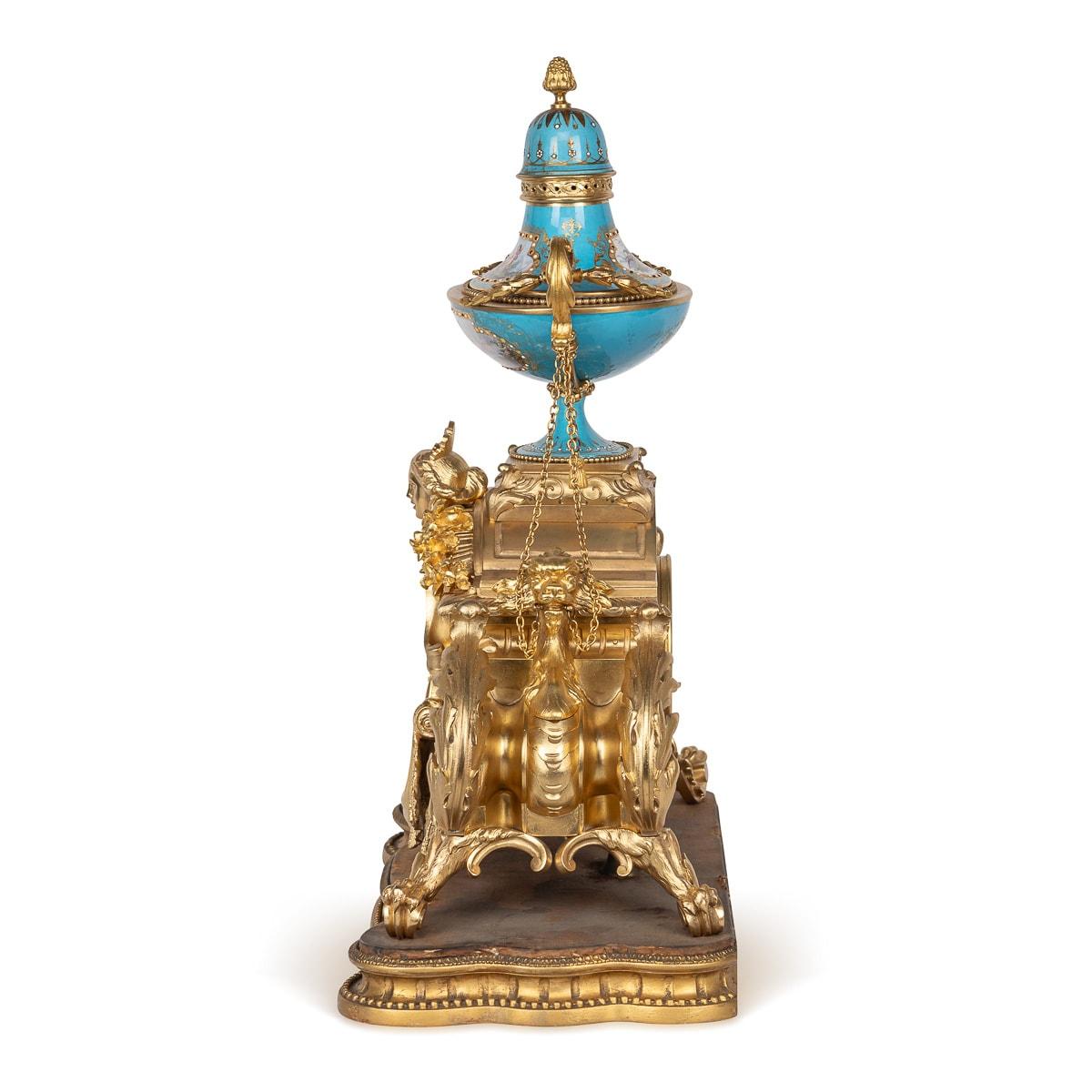 Antique 19th Century French Louis XV style mantel clock, a captivating piece fashioned from Sevres style porcelain and adorned with ormolu accents. Atop the clock rests a striking 'bleu celeste' painted porcelain urn, complemented by a fruit cone