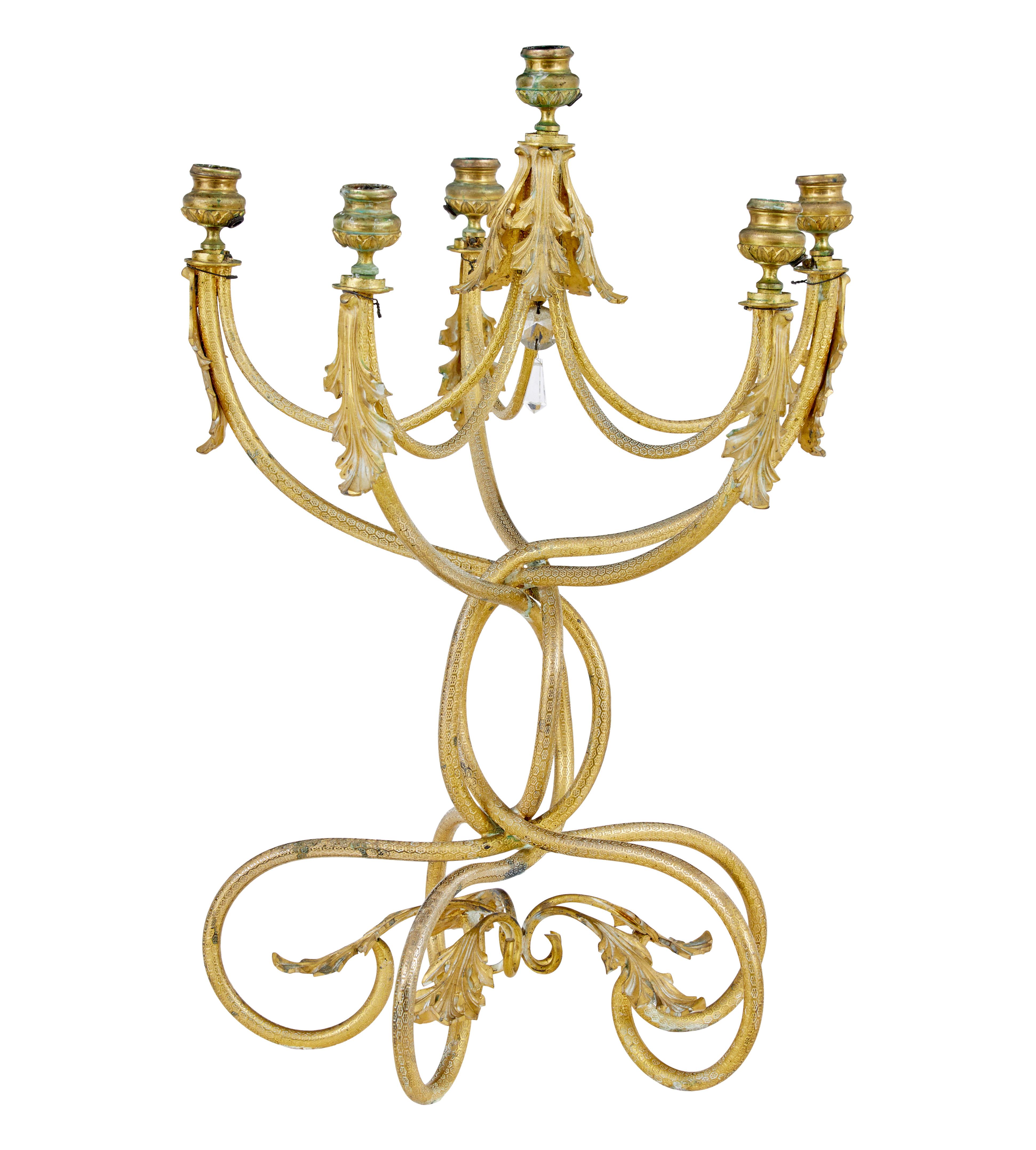 19th century French ormolu six-candle candelabra circa 1880.

Fine quality chiselled ormolu craftsmanship on this piece.  Stamped with a hexagonal pattern all over.  Six arms, five on the lower tier and a further arm in the centre in an elevated