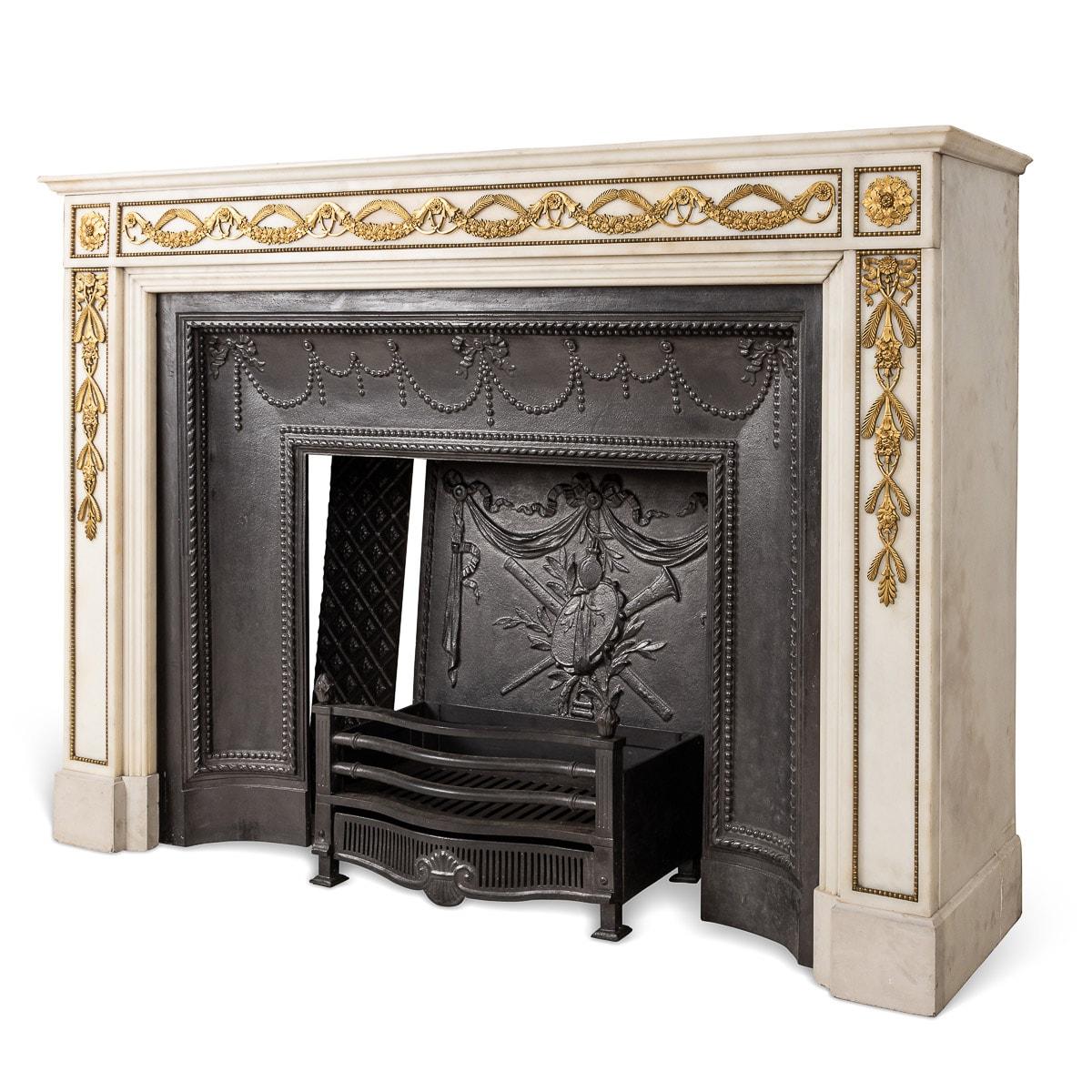 Antique mid-19th century French Empire white marble fireplace with ormolu mounts. The moulded panelled jambs applied with gilt bronze laurel foliage swags with rosettes on each corner, fitted with the surround cast iron fire back, fire pit and