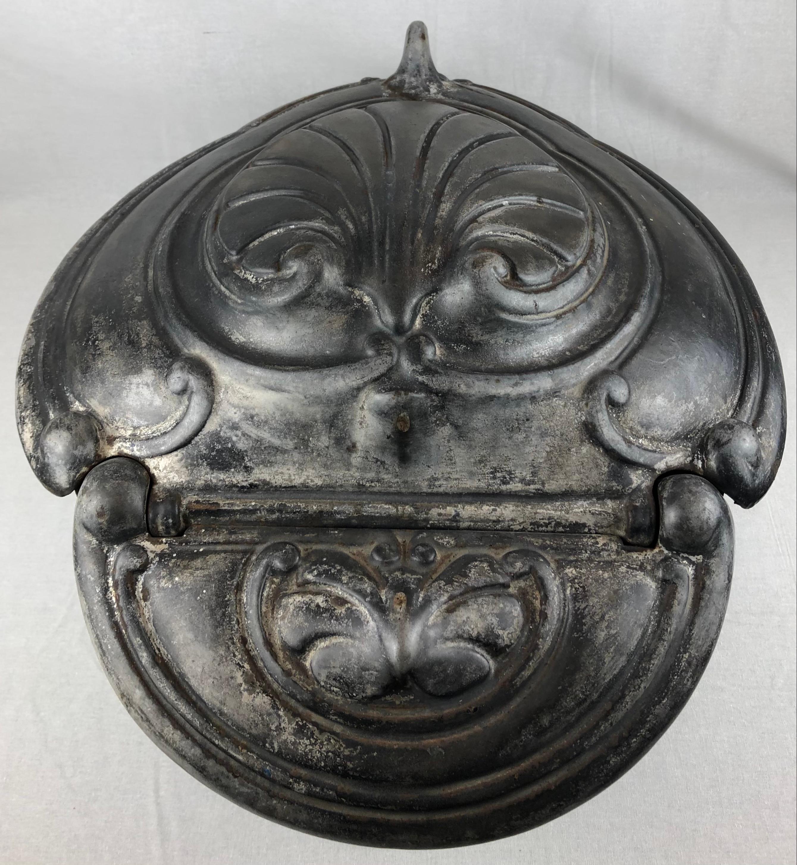 A completely original 19th century French polished cast iron fire basket grate in the Rococo style. 

A shaped high back complete with its original fire stone, with a four bar serpentine polished grate front topped by polished flame finials, and