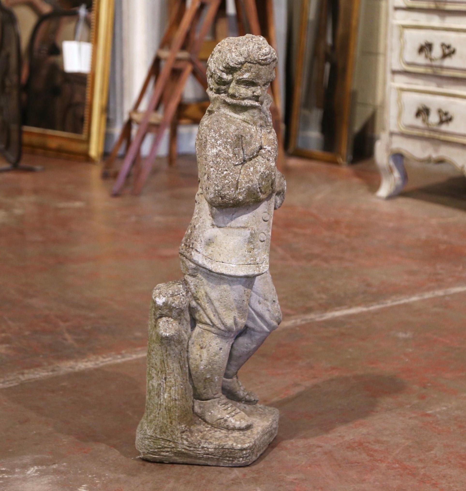 Decorate a garden or patio with this elegant antique outdoor statue; hand carved of stone in France circa 1880, the figure depicts a young gentleman in a standing position shielding the cold wing coat with his coat; wonderful body expression and