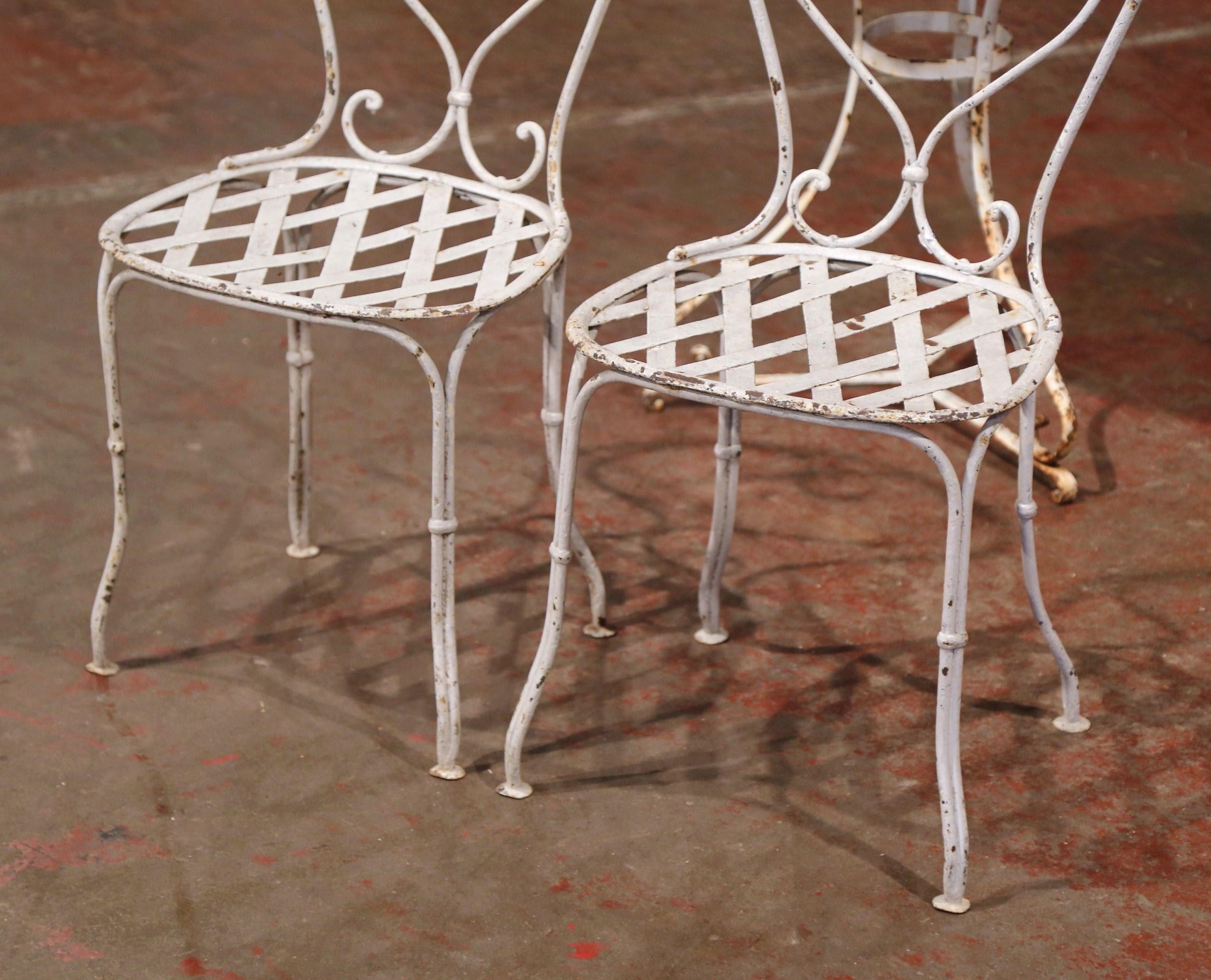 Decorate an outdoor or a patio with these antique Bistrot chairs. Crafted in France circa 1880, each chair features a back with scroll decor and a seat with weave decor. The chairs are in excellent condition commensurate with age and use and adorn