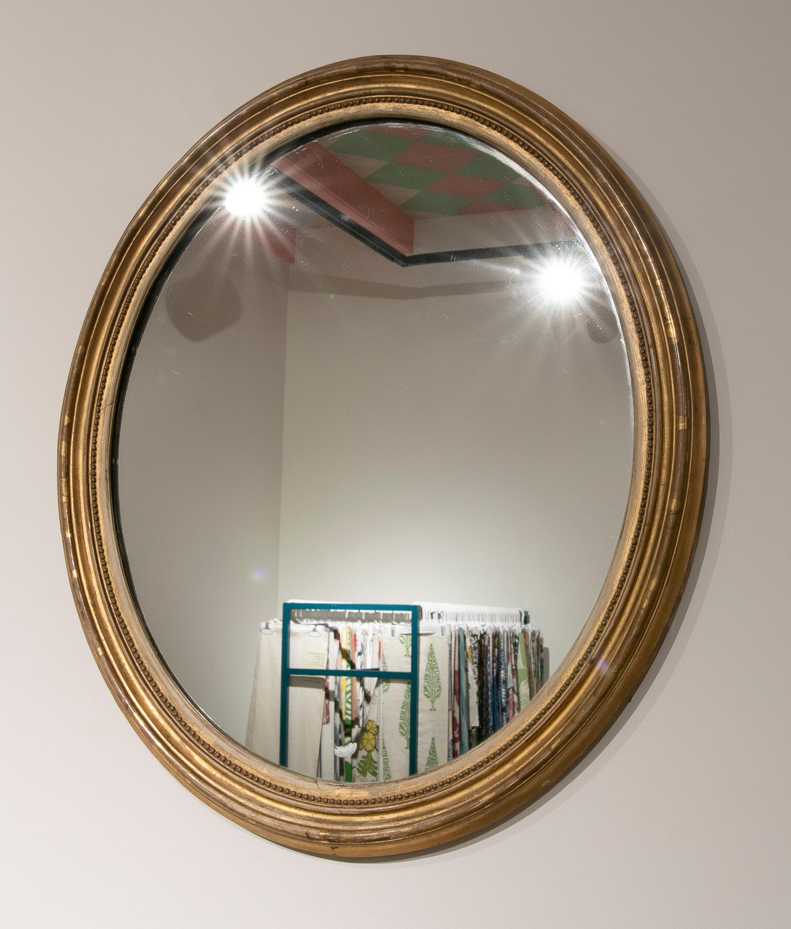 19th Century French oval giltwood mirror.