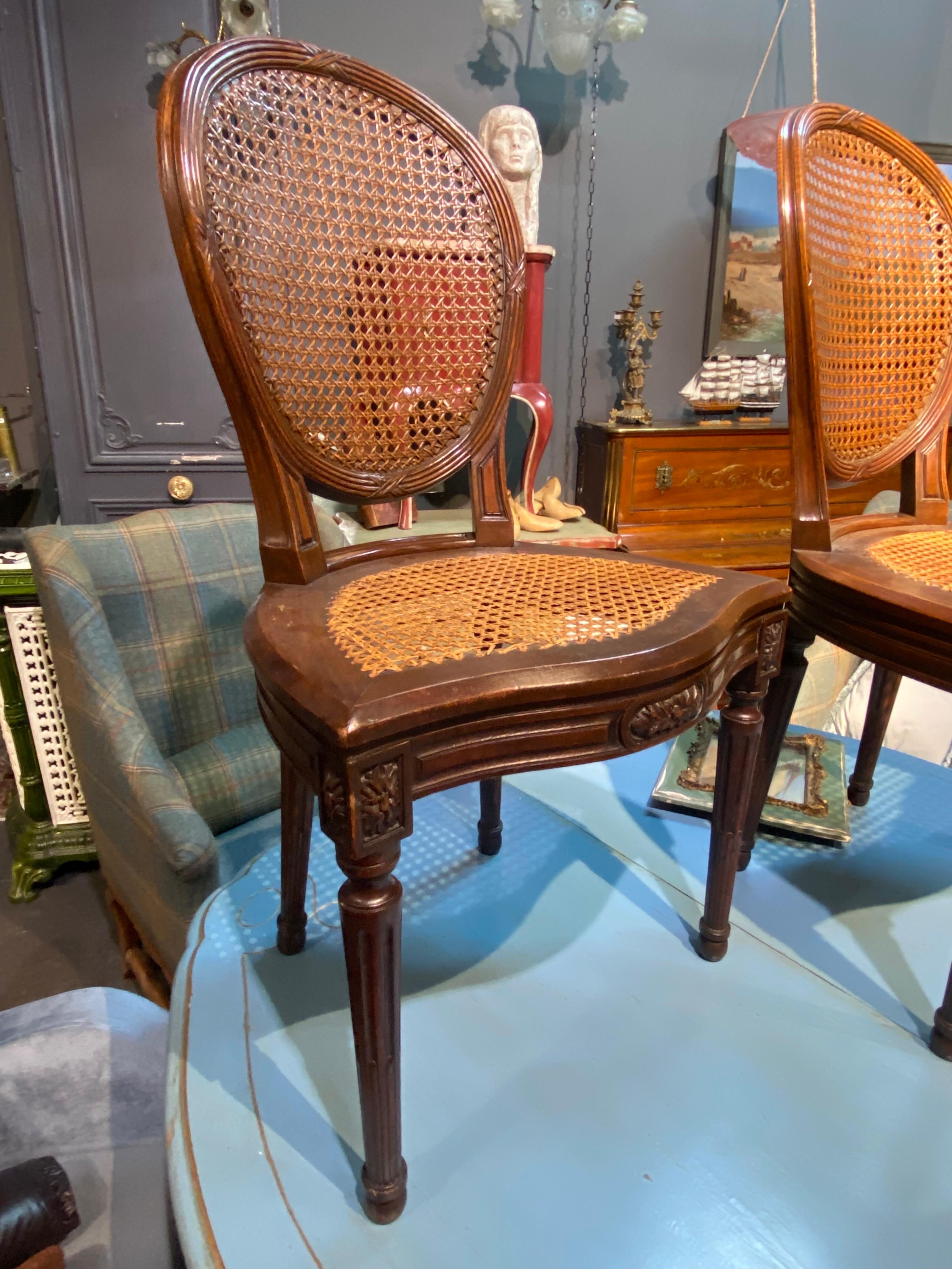 Hand-Carved 19th Century French Oval Hand Carved Walnut Cane Dining Chairs Louis XVI Style For Sale