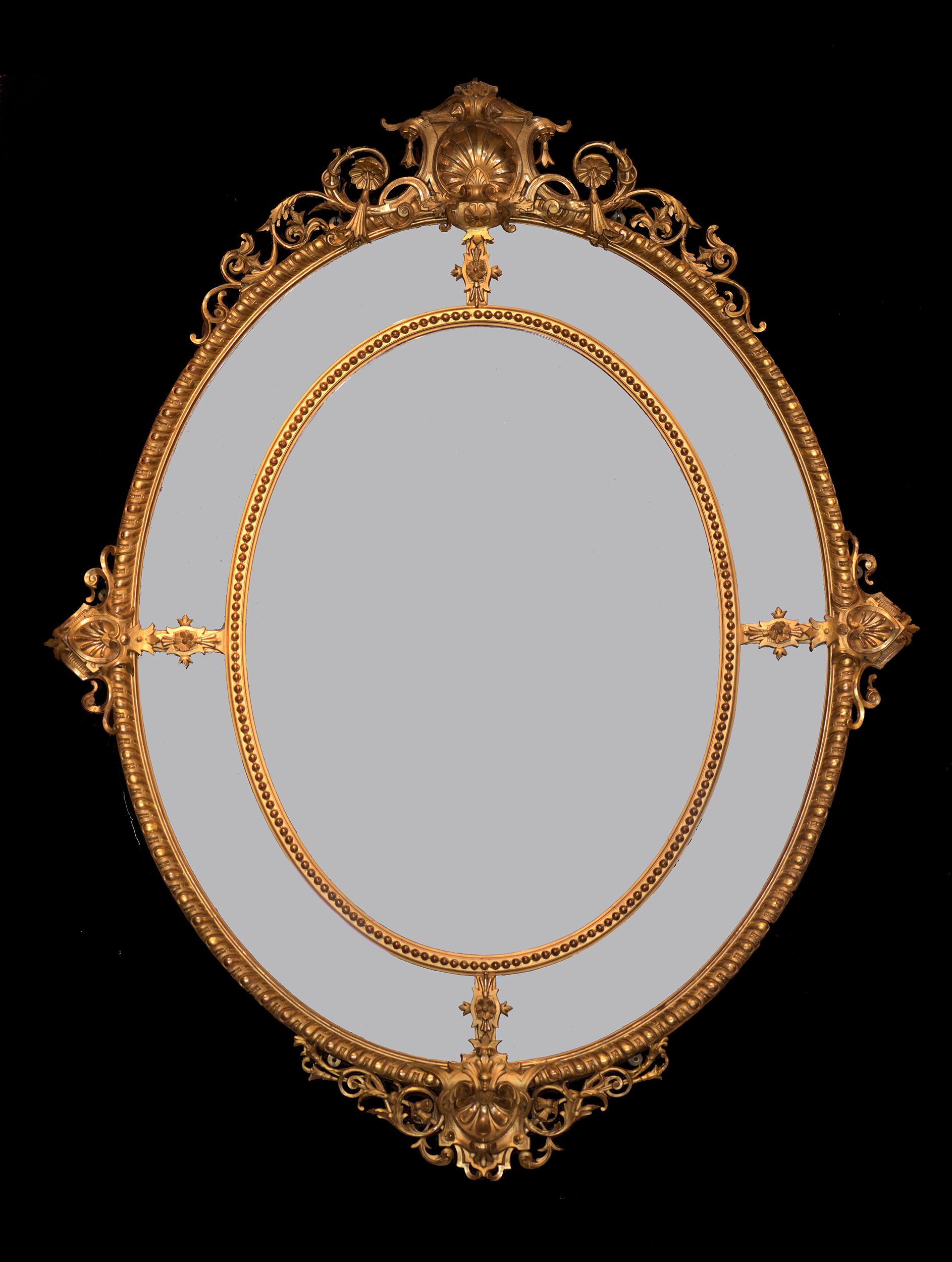 A magnificent French carved giltwood oval marginal wall mirror, of large proportions, surmounted by a shell and pierced foliage.

Circa 1870

French

Dimensions:

H: 74 1/2 in / 189 cm
W: 59 1/2 in / 151 cm