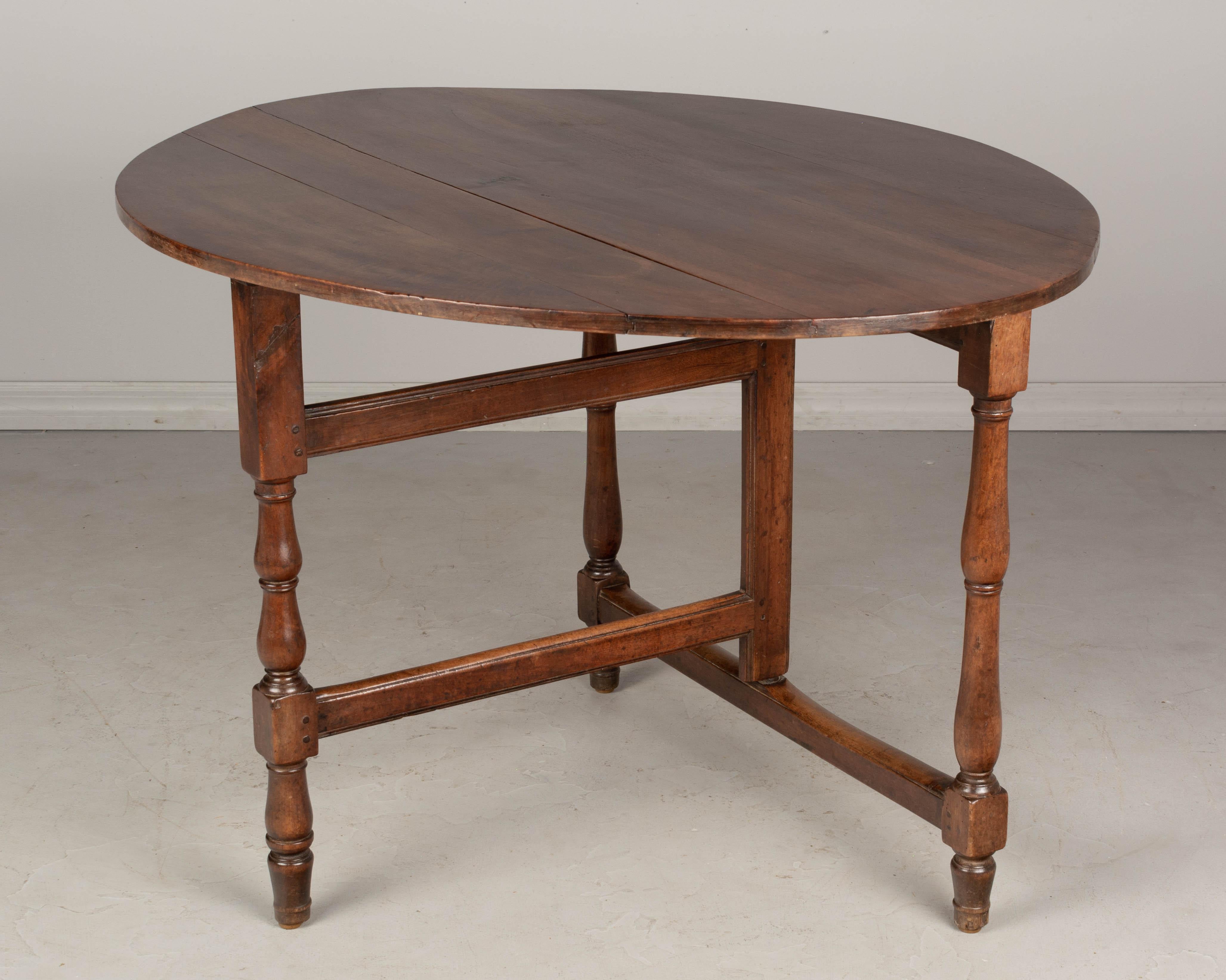 Hand-Crafted 19th Century French Oval Walnut Folding Table