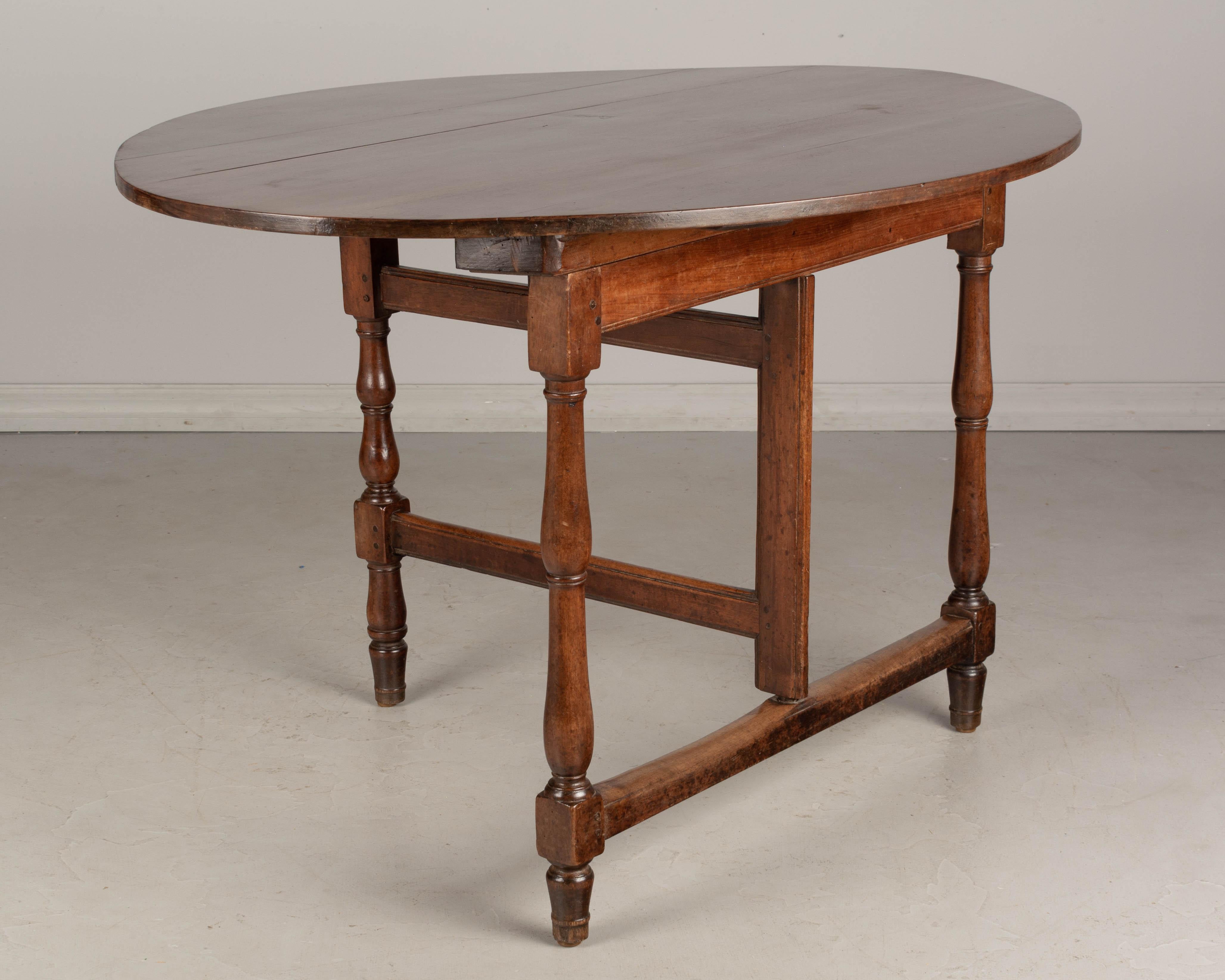 19th Century French Oval Walnut Folding Table 1