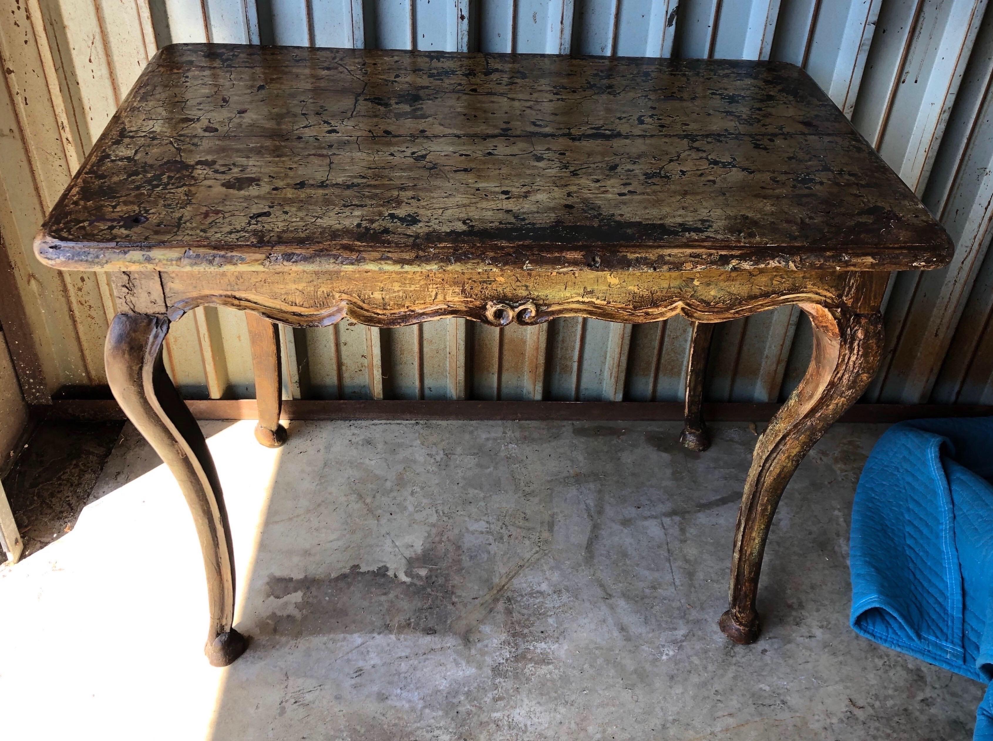 Early 19th century French paint decorated table with carved cabriole legs and scalloped skirt. Incredible color and patina all around.