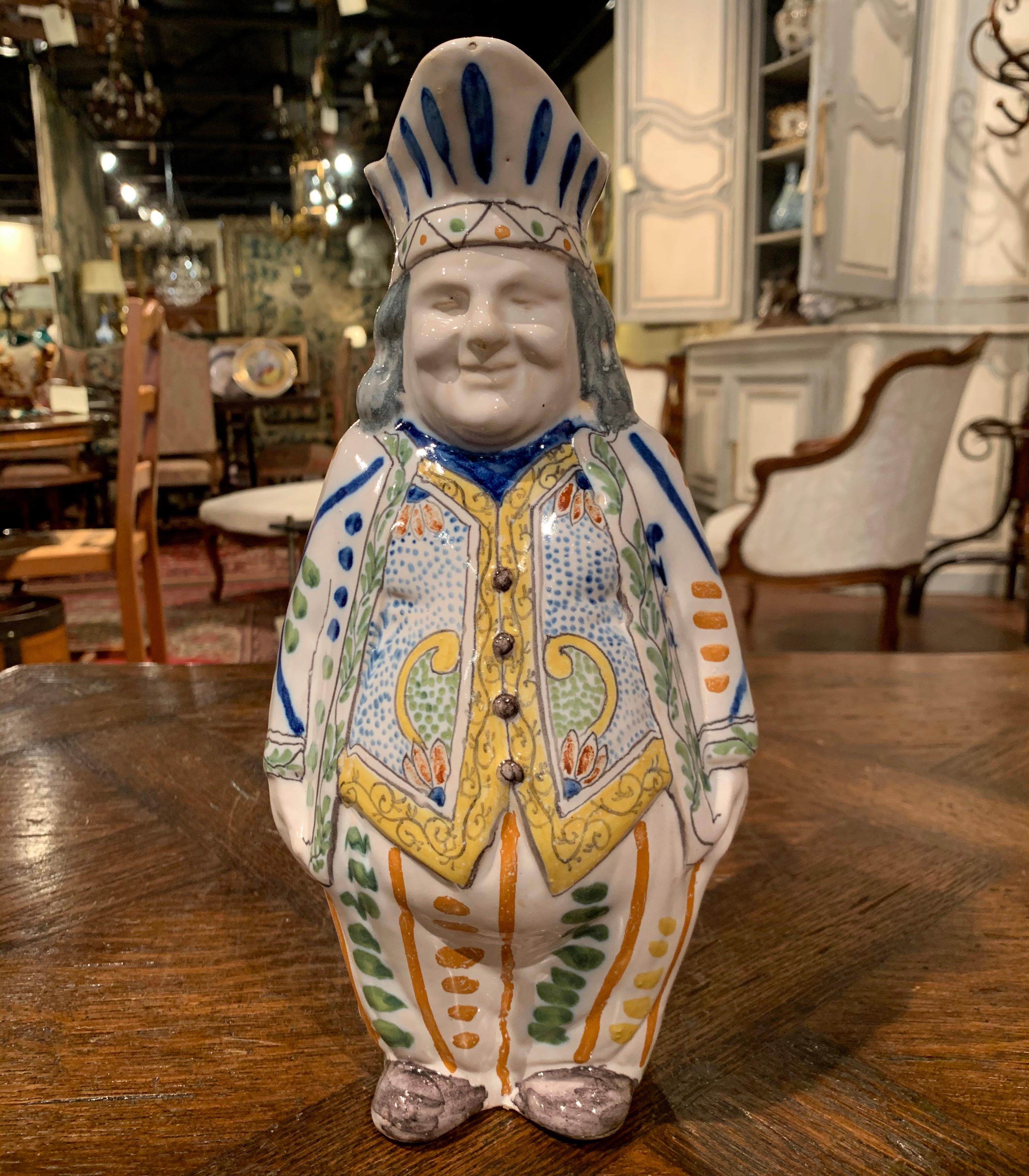 Decorate a wet bar or a shelf with this charming antique Majolica pitcher, crafted in central France (probably in Malicorne) circa 1880, the colorful pitcher features a smiling man's sculpture dressed in tuxedo and toque. The sculptural carved