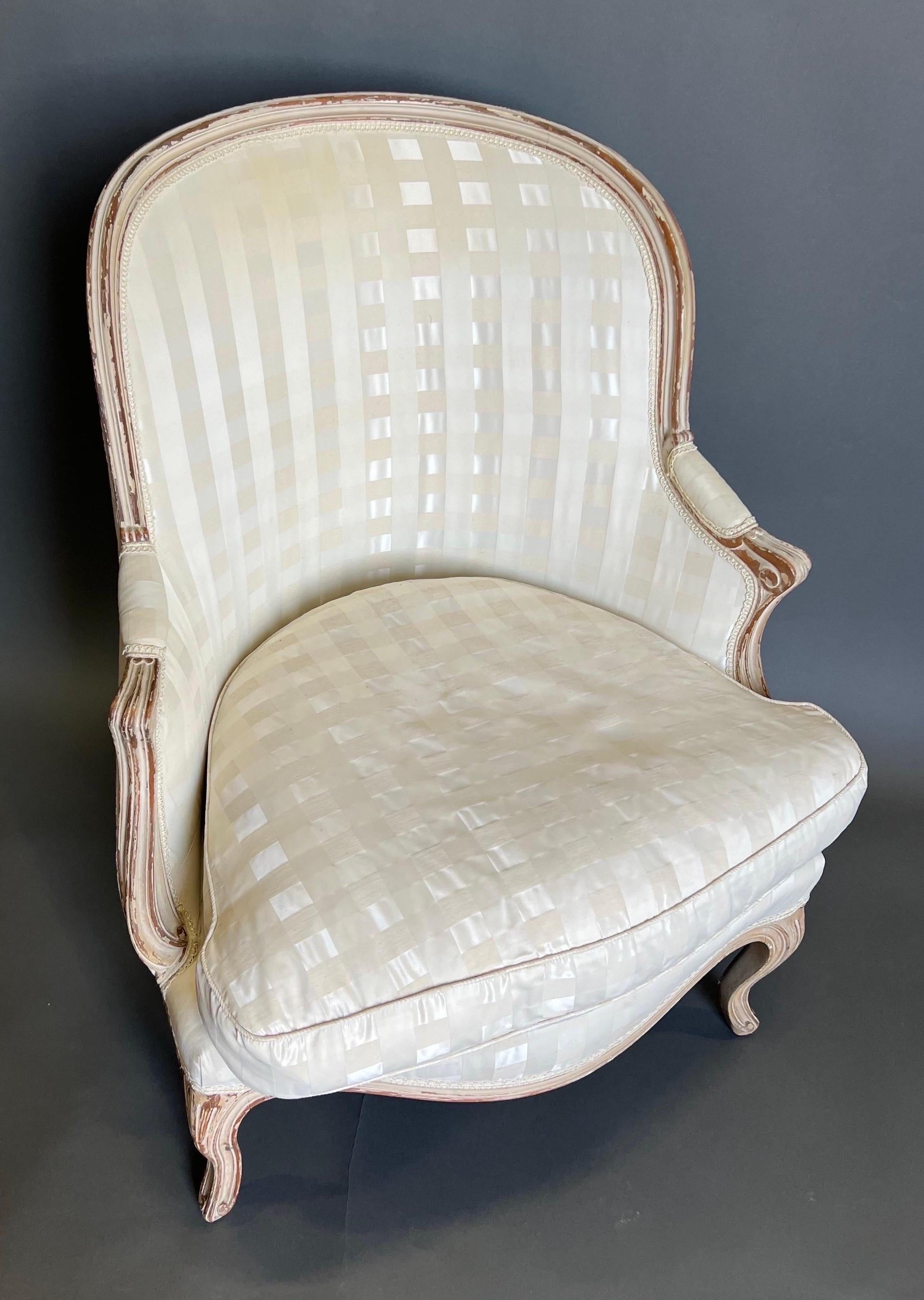 19th century French painted bergere beautifully upholstered in an off white fabric. The chair was recently acquired from an estate with a fabulous corner apartment in the exclusive Carlyle building in Manhattan. The owner furnished most of the