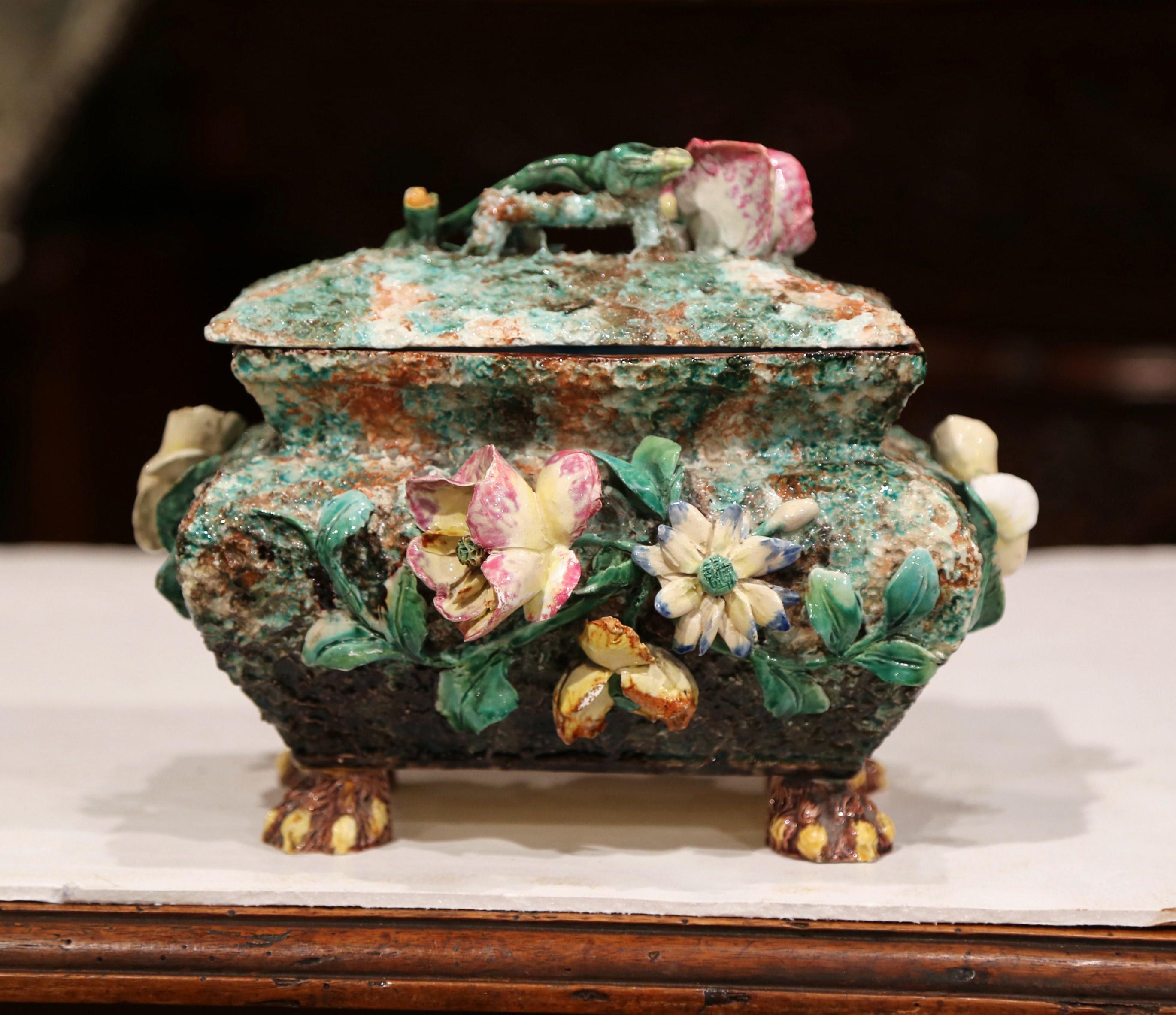 Decorate a shelf with this elegant and colorful antique Majolica box. Crafted in France circa 1860, the decorative ceramic piece sits on small feet with claws. The whimsical bombe casket is fully decorated on all four sides in realistic high relief