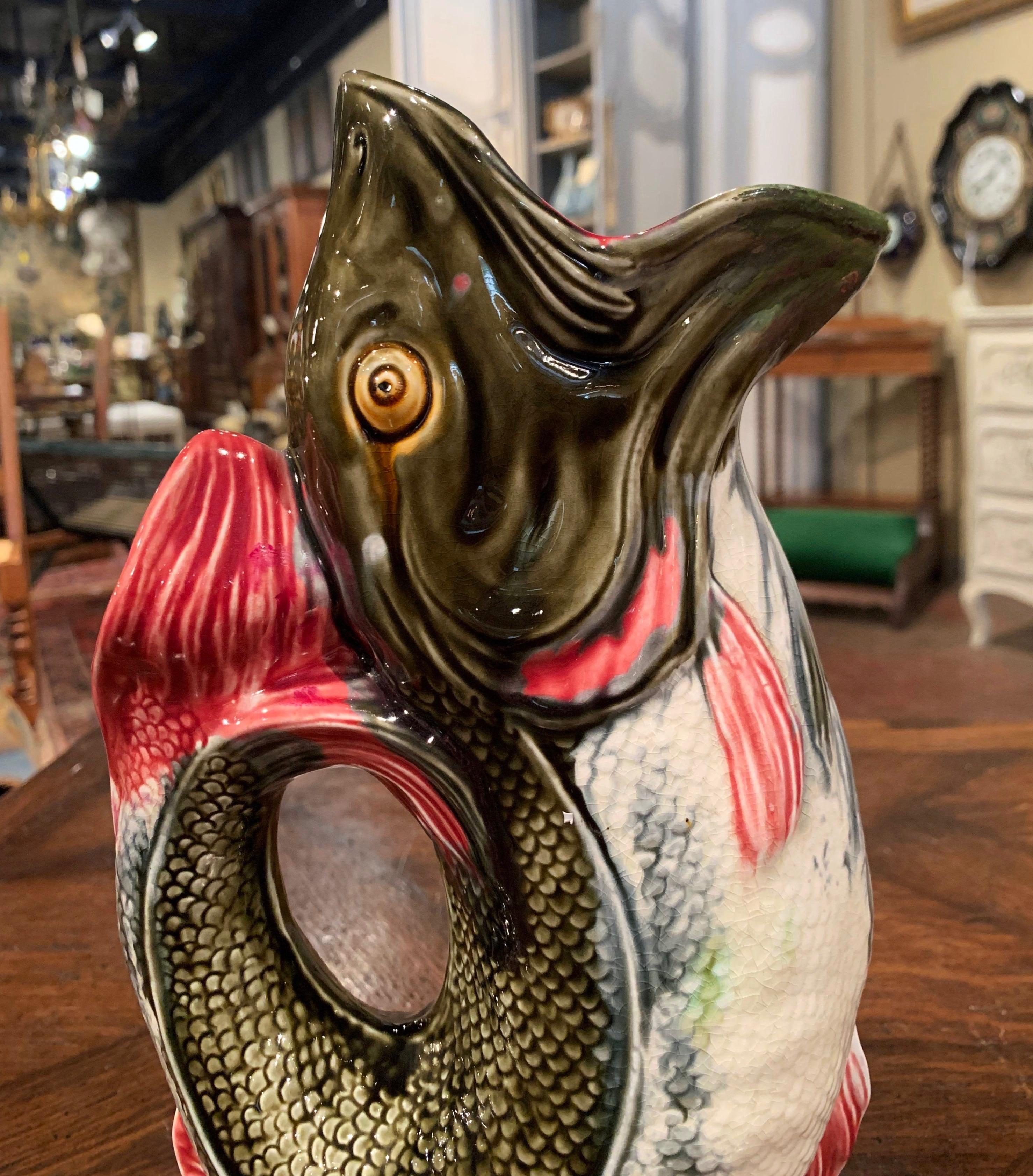 This lively antique pitcher would make an interesting addition to any porcelain collection. The harmonious porcelain jug was sculpted in France, circa 1890 and is in the shape of a colorful fish in a standing position with a wide open mouth; called