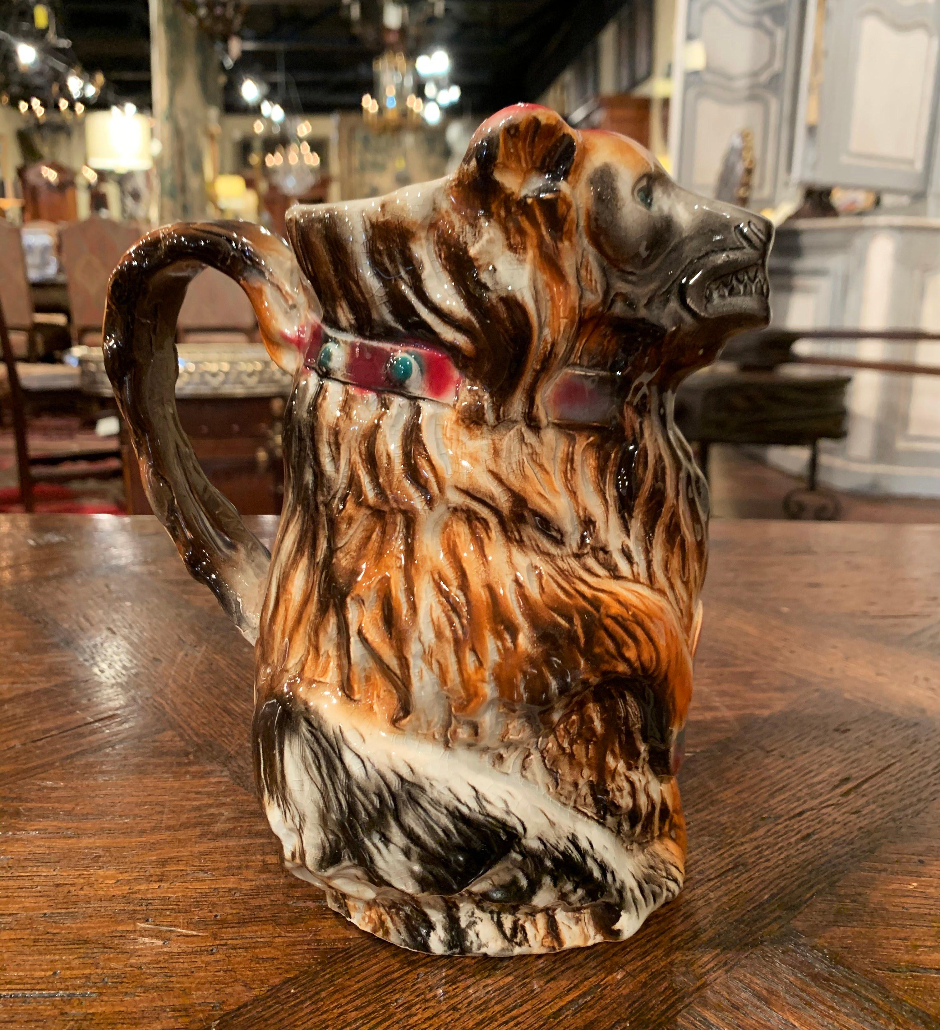 Add to a whimsical porcelain collection with this elegant antique Majolica pitcher. Crafted in southeast France circa 1890 in the faiencerie Coursange of Poet-Laval, the figural pitcher features a standing bear with his front arms resting on his