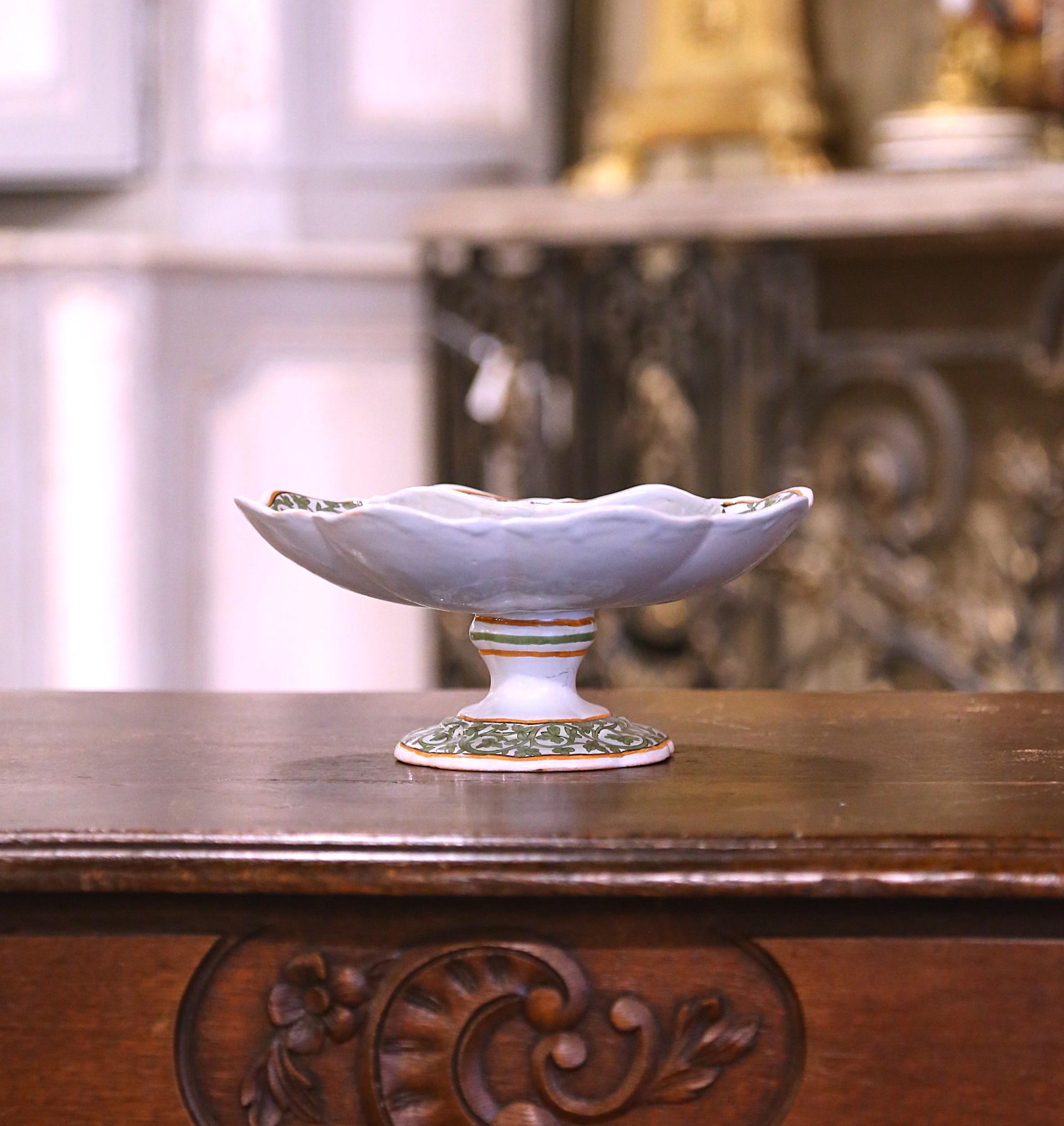 Serve chips and salsa, or even queso, in this exquisite antique dipping compote dish. Crafted in Brittany, France, circa 1890, this hand-painted faience dish features a charming clover shape with elegantly scalloped edges. Designed for both beauty