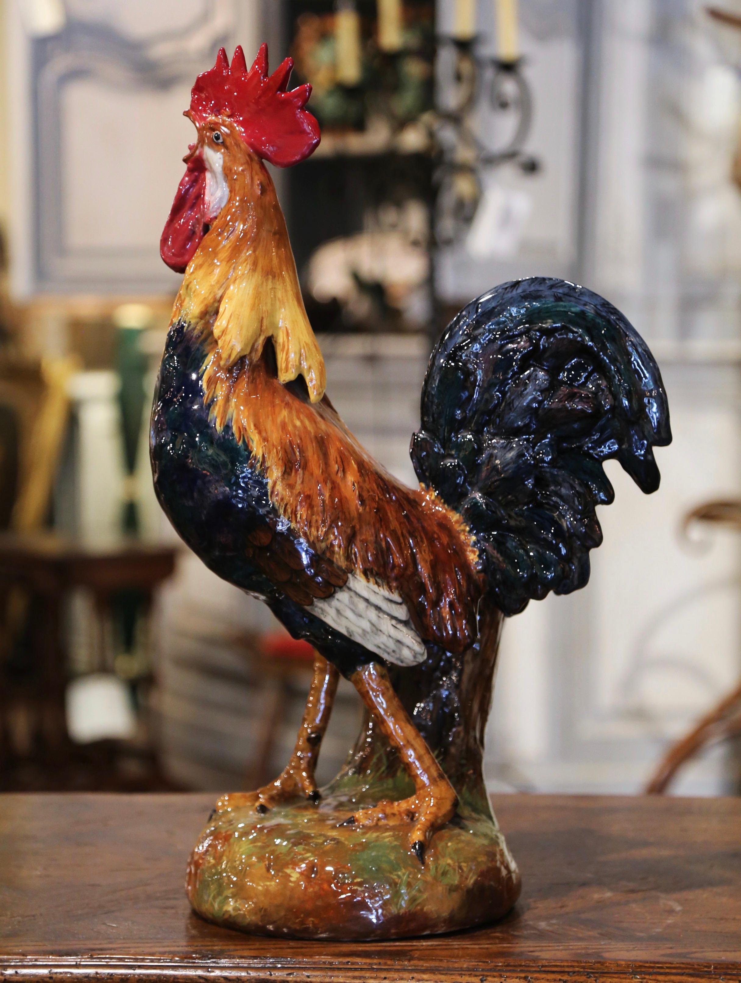 Add the charm of the French countryside to your home with this large, colorful and rare ceramic rooster sculpture. Crafted in France circa 1880 in the style of Paul Comolera or Louis Carrier Belleuse, the Majolica composition is at once a flower