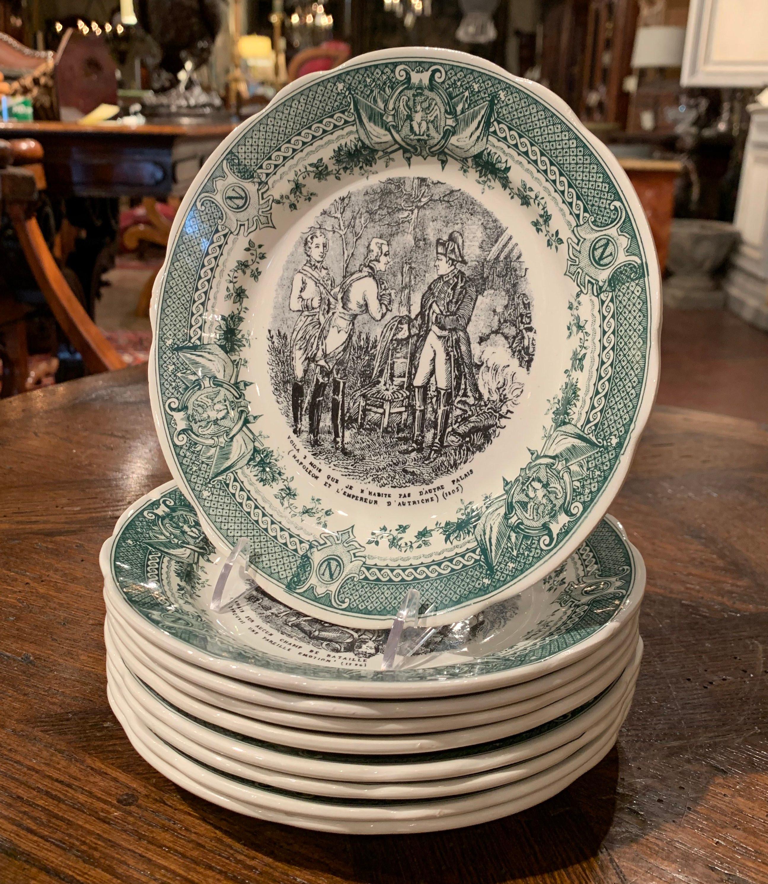 Use this elegant set of eight antique plates to serve appetizer or desert to your guests! Crafted in Sarreguemines, France, circa 1950, each hand painted ceramic plate features the Emperor Napoleon Bonaparte with an illustrated scene and one of his