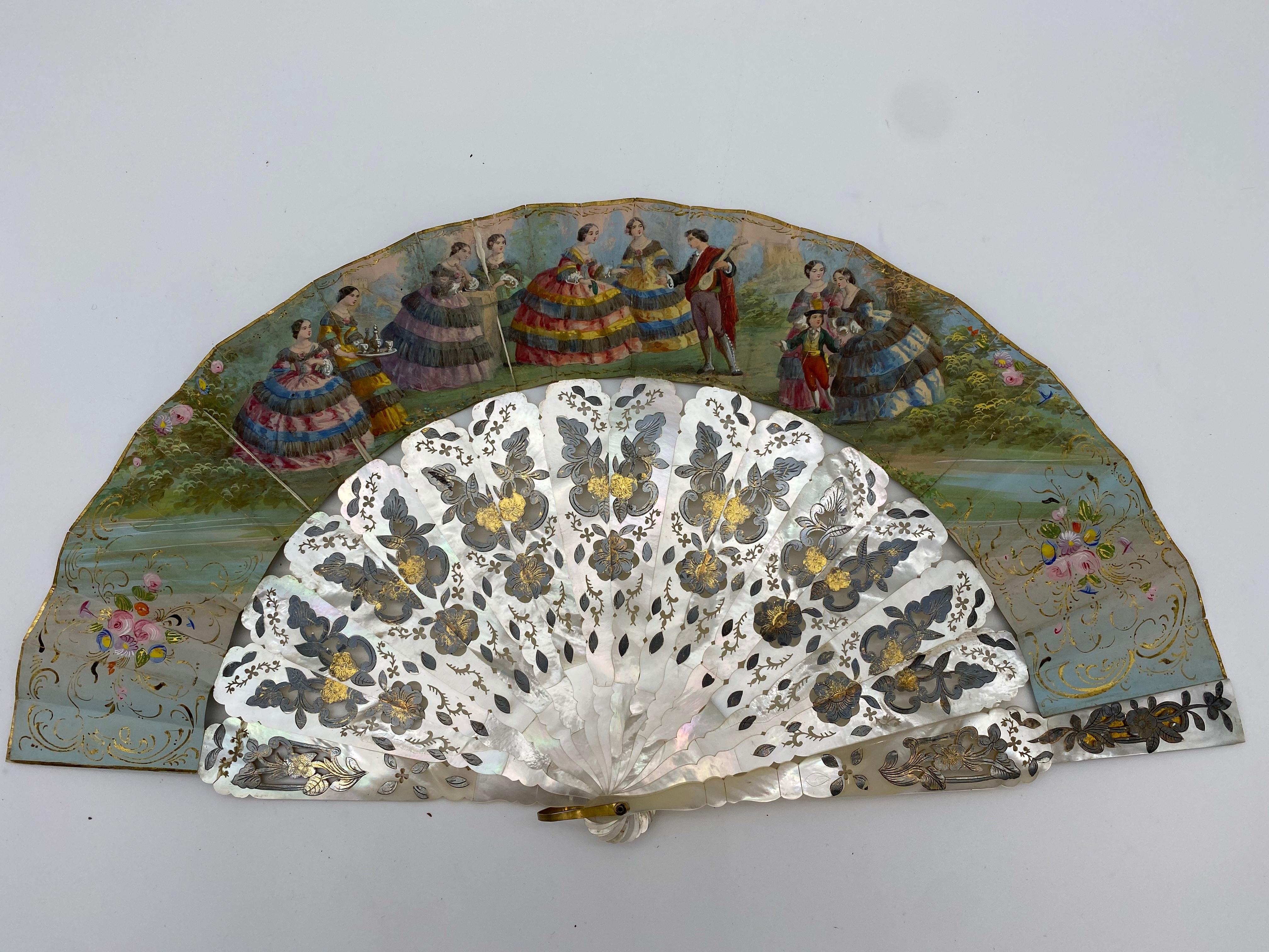 This ornate, antique paper and mother of pearl hand fan was crafted in France, circa 1850. Showing a guitarist charming a female assembly. Spanish dancers on the back.
The sheets in lithographed and gouache paper. The frames in pierced, engraved