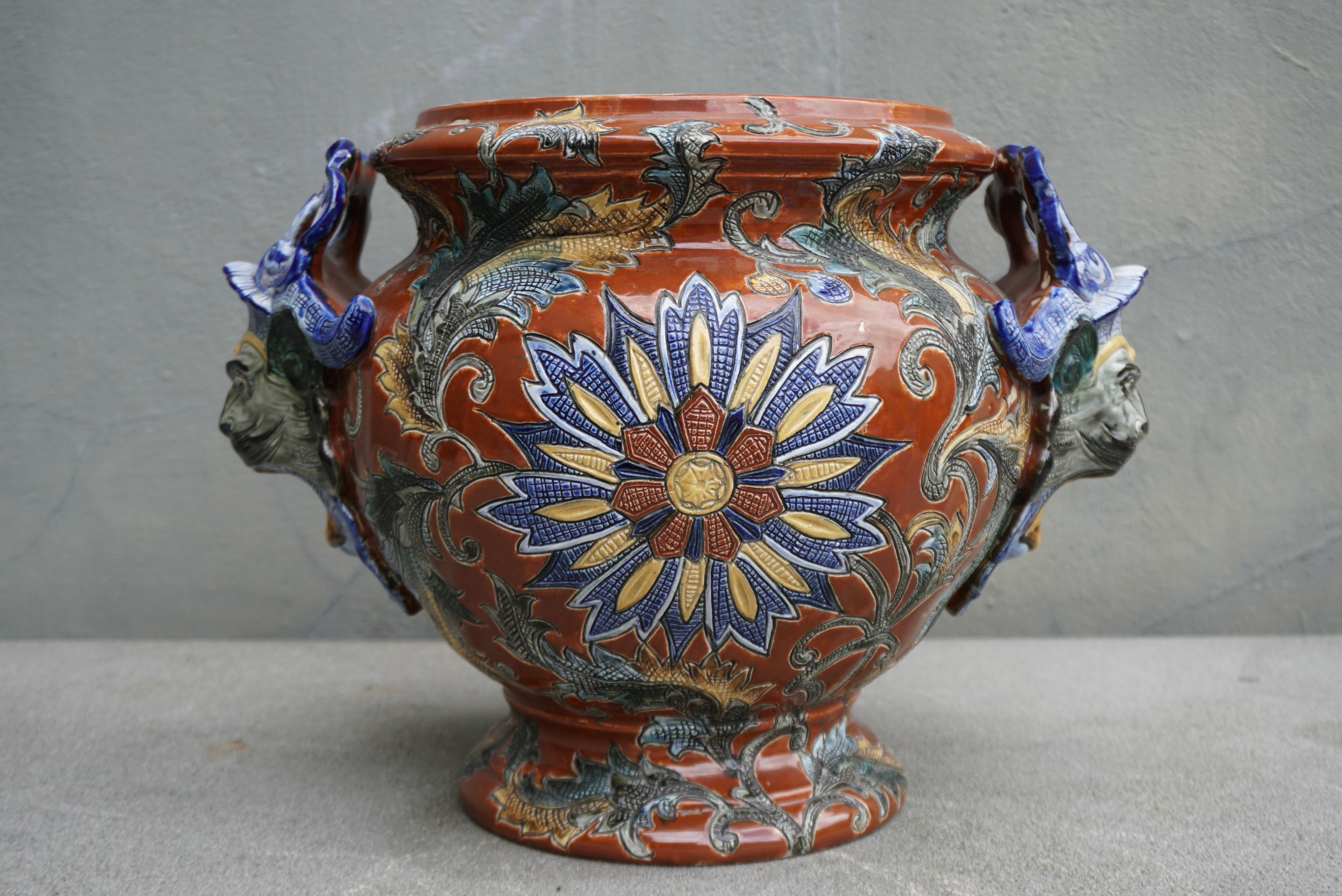 This round and colorful antique planter, flower pot was created in France, circa 1890. The elegant porcelain piece is in excellent condition with rich painted colors in the blue, brown and yellow. 

Height 12.9