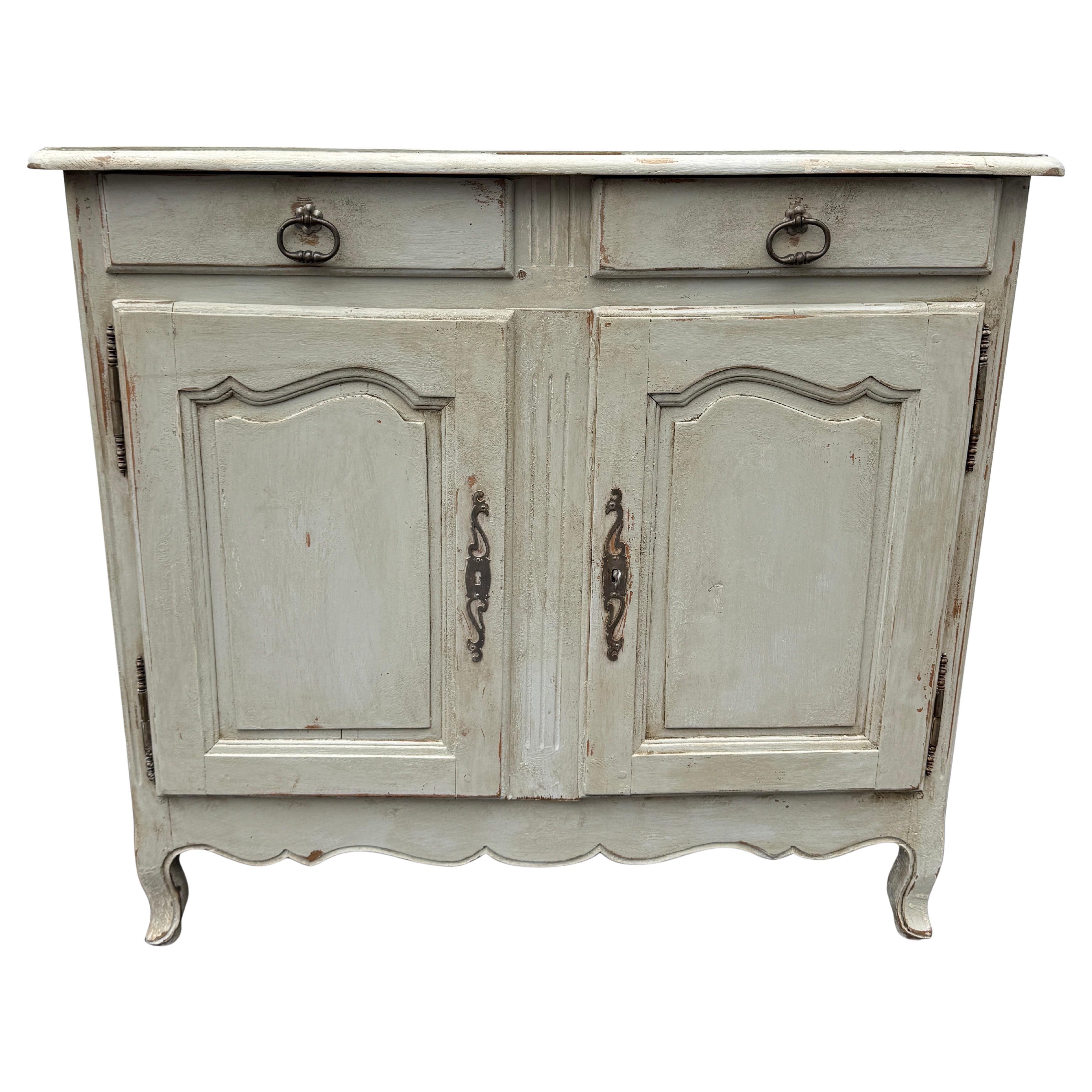 Painted Commode Cabinet with Doors and Two Drawers. Gustavian styled hand painted French sideboard constructed from solid wood. This piece features a hand-applied distressed finish with brass hardware. This cabinet brings vintage old-world charm to