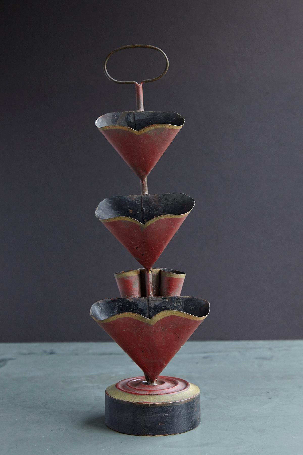 Late 19th century French three-tier tole candy or cookie display stand, painted in red with a gold trim mounted on a black and gold paint wooden base with a top handle for serving. The stand has it's original paint and a nice patina.
 