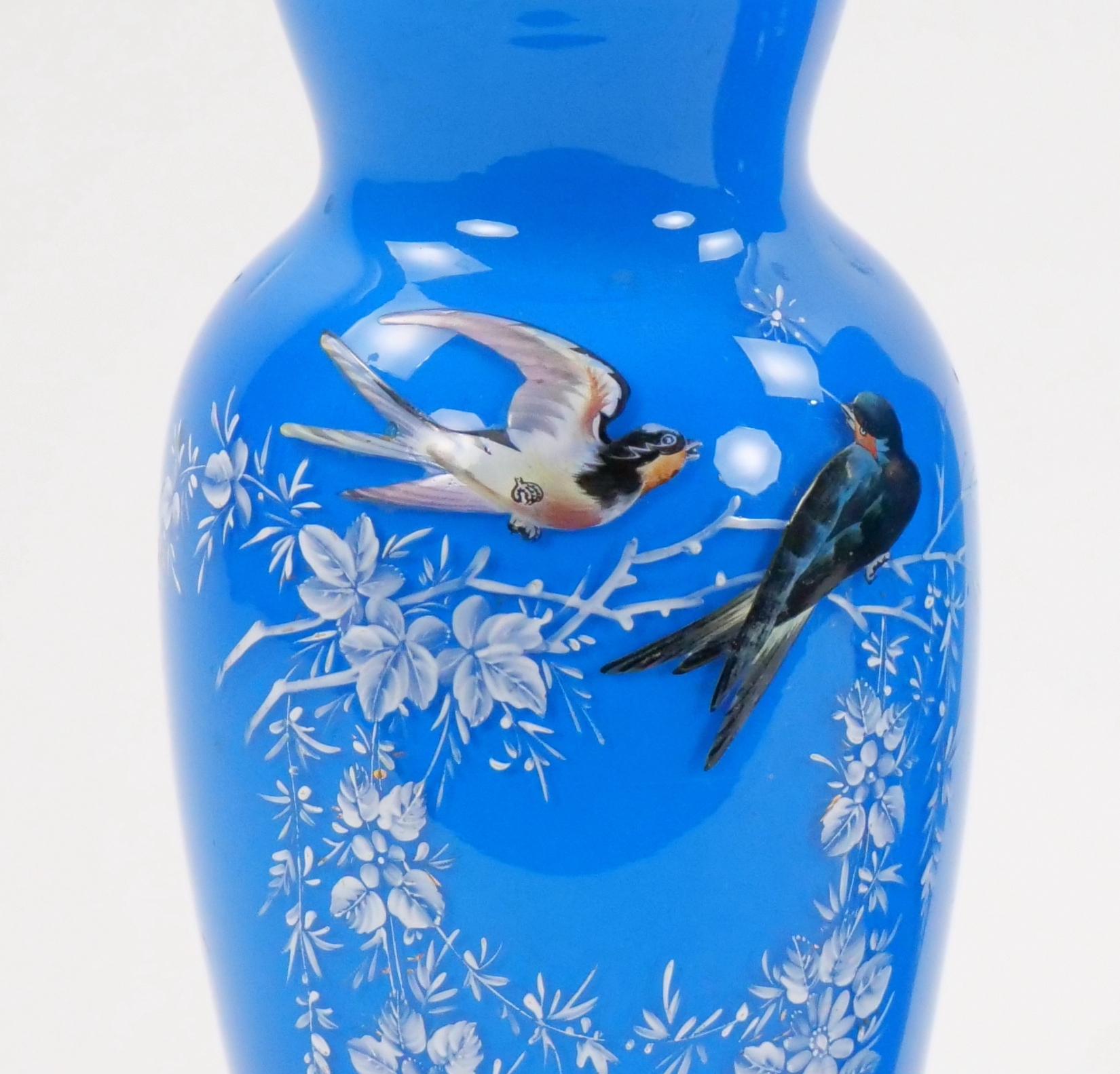 
Step into the world of 19th-century French artistry with our exceptional pair of hand-painted and meticulously decorated art glass vases, adorned with captivating depictions of songbirds in their natural splendor. These vases stand as a testament