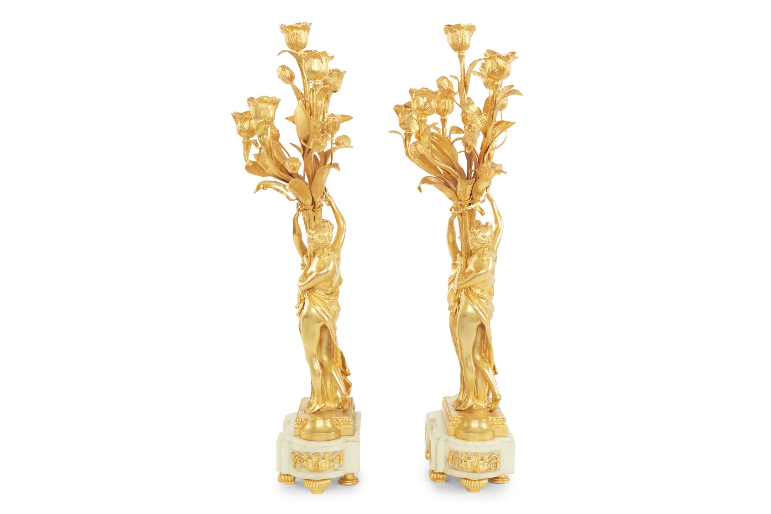 19th century pair of gilt bronze ormolu / marble Louis XV style six light gilt candelabras. Each candelabra featuring with a pair of barefooted maidens draped in fabric with matching buns with rosettes, each holding up the candelabra arms shaped