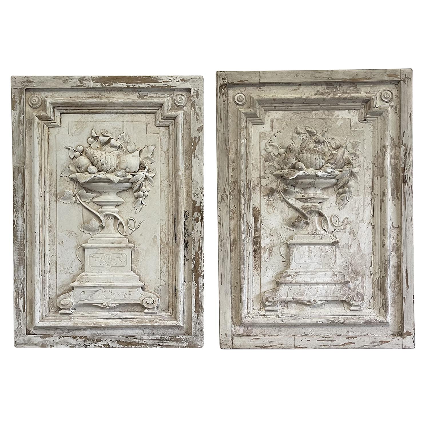 An antique set of two French door casing, in good condition. These vertical wooden wall panels have stucco applications and are abundantly adorned with the typical motives of the Baroque style: centered urns on pedestals with flowers and branches,