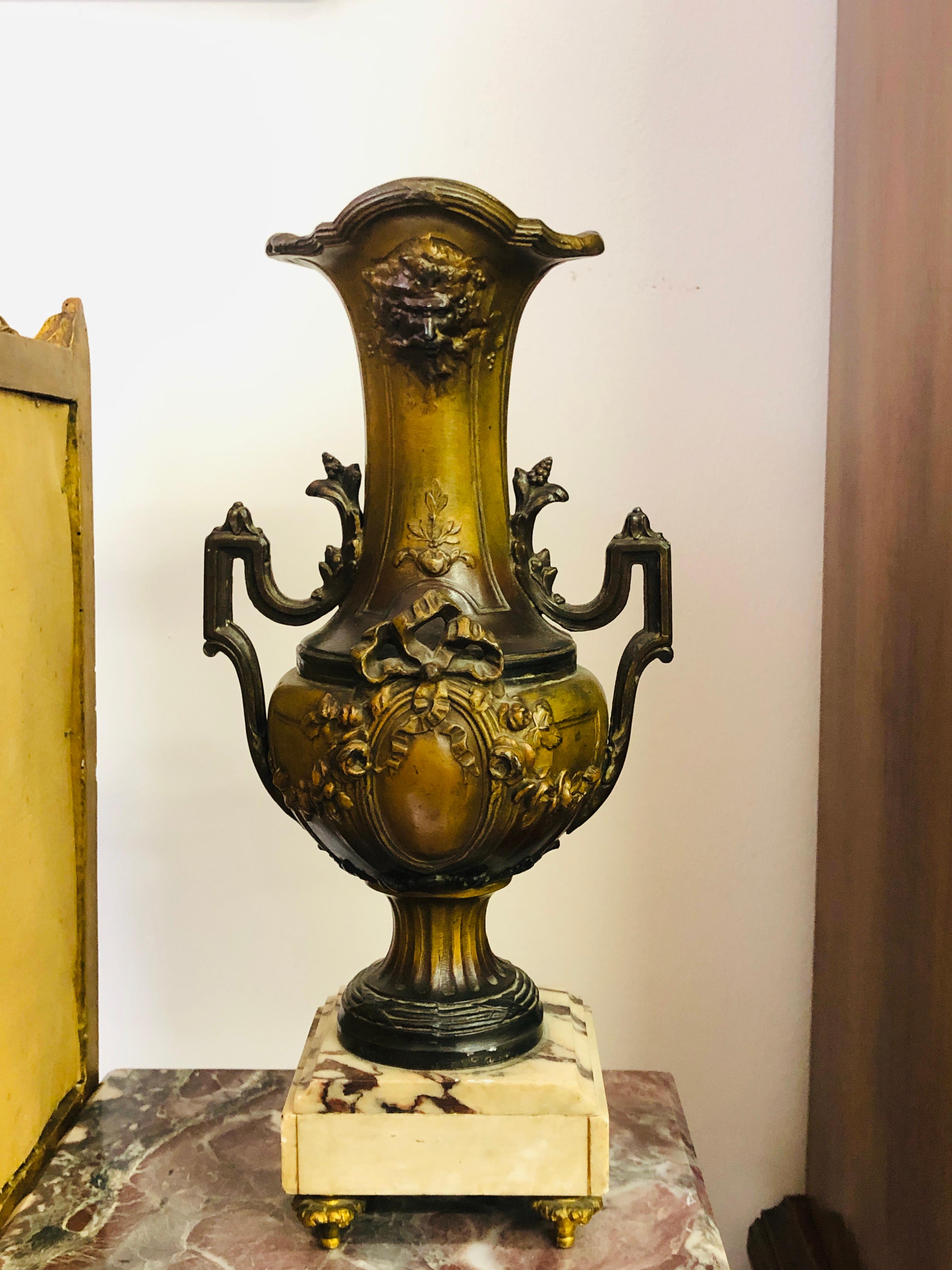 French pair of vases with brown patina, decorated in Louise XV style, standing on white marble base. Very good condition,
circa 1890.