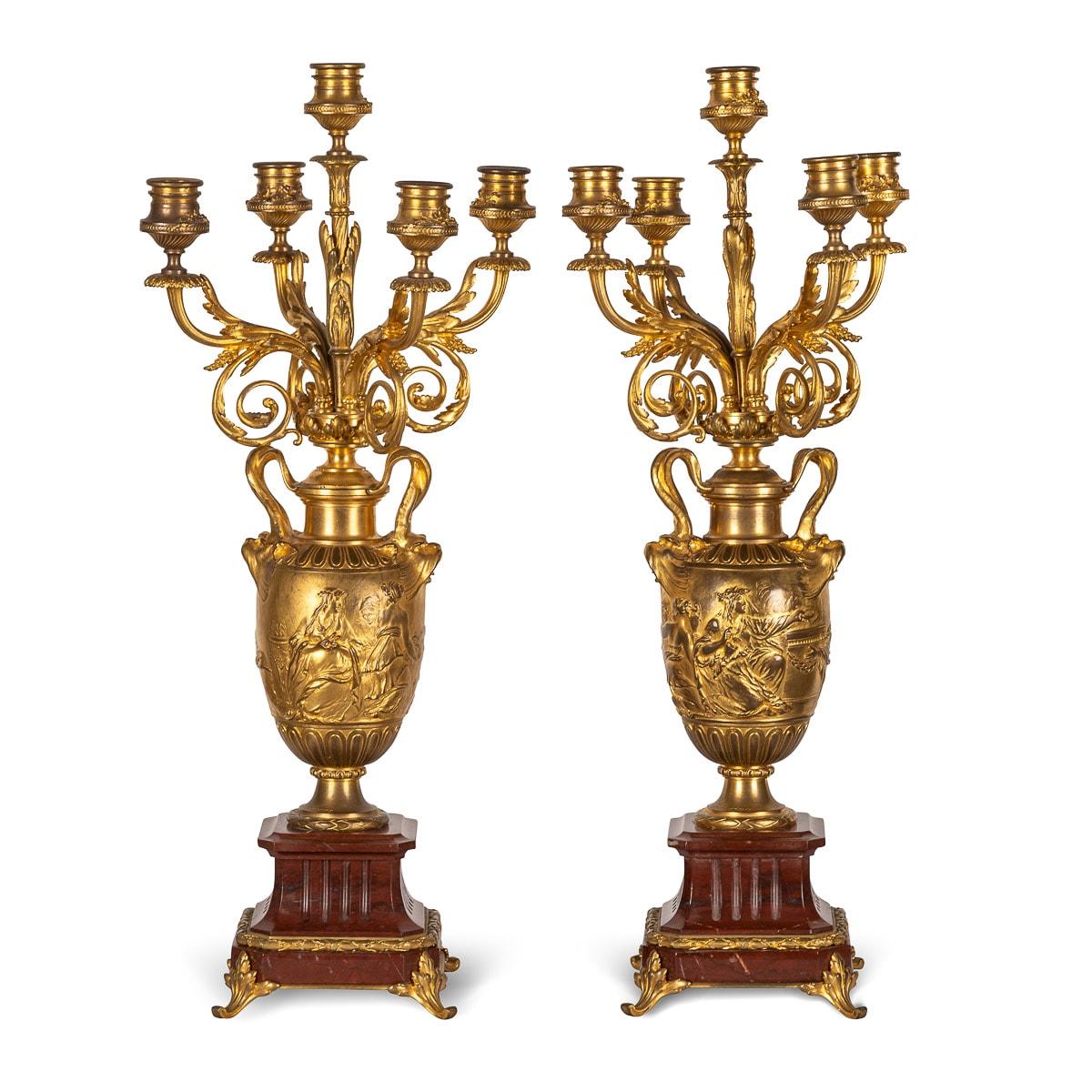 Antique 19th century French pair of bronze and marble candelabras. These exceptional candelabras are by the renowned metalworker Ferdinand Barbedienne, made from rouge griotte marble and and applied with ormolu bronze. Each candelabrum standing on a