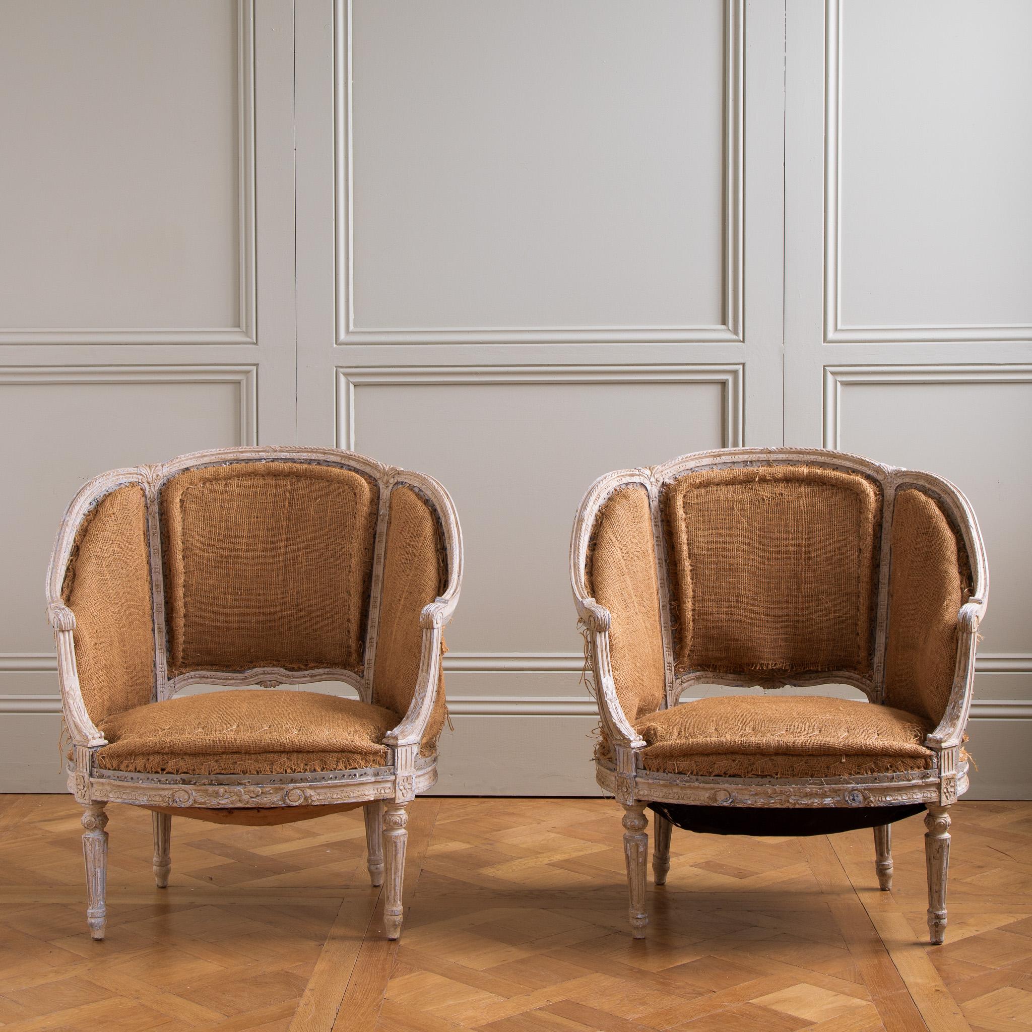 A rare find of exquisitely hand-carved  19th Century Corbeille Bergere, Louis XVI Style, French Armchairs, Circa 1800s. The Chairs have beautiful proportions with the attention to detailing of the period. The patina has a naturally age-distressed