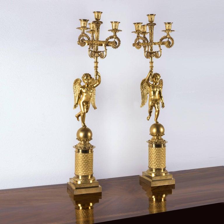 From a luxury villa at Como Lake a stunning pair of early 19th century Empire four-light gilt bronze figural candelabras, of French origin, dating back to circa 1810, measure: 31.50 inches high. Extraordinary high-quality casting, chasing, engraving