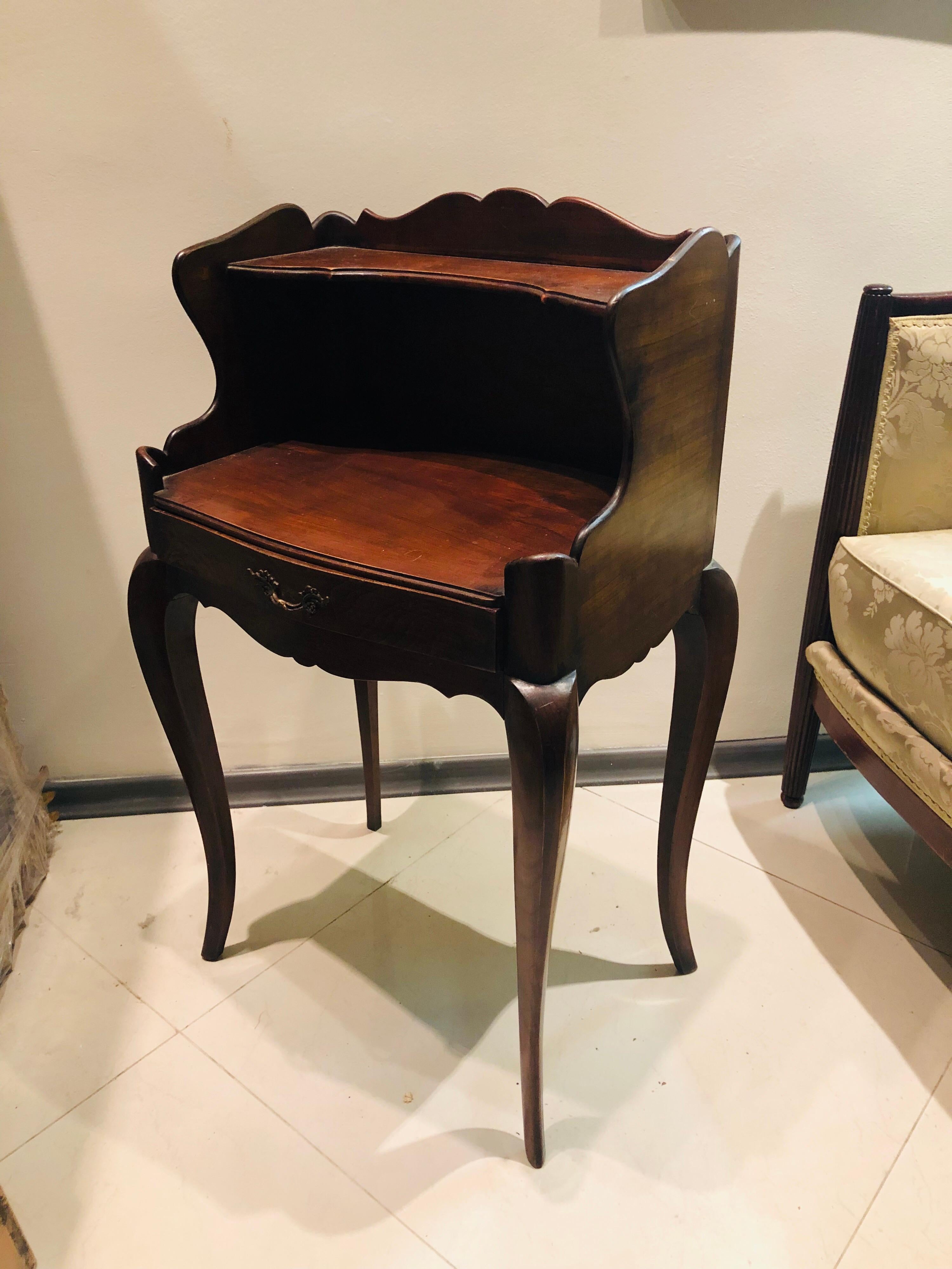 Two elegant mahogany nightstands or side tables in Louis XV style with small front drawer.
France, circa 1870.