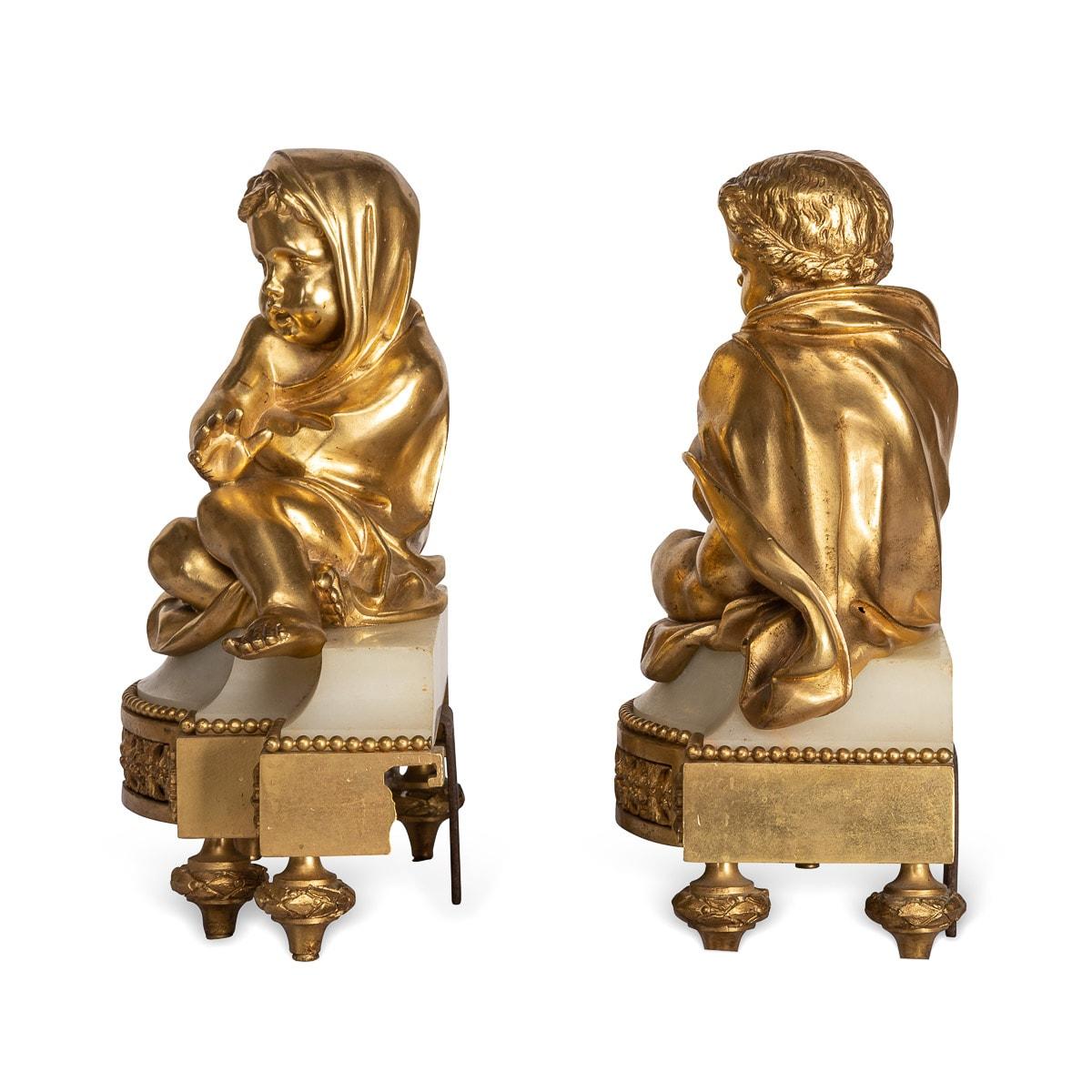 Antique mid 19th century French beautifully cast pair of gilt bronze fireplace chenets. These chenets are adorned by reclining puttis on a beautiful marble base, decorated with beautiful floral rosetts, floral bands on shaped garland