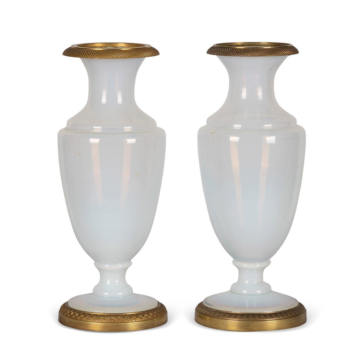 Antique early-19th Century French pair of Ormolu mounted opaline vases, of baluster shape with trumpet necks and stepped circular feet. The rim mount is cast in Ormolu, with beading pattern and the base has a floral leaf design. The overall finish