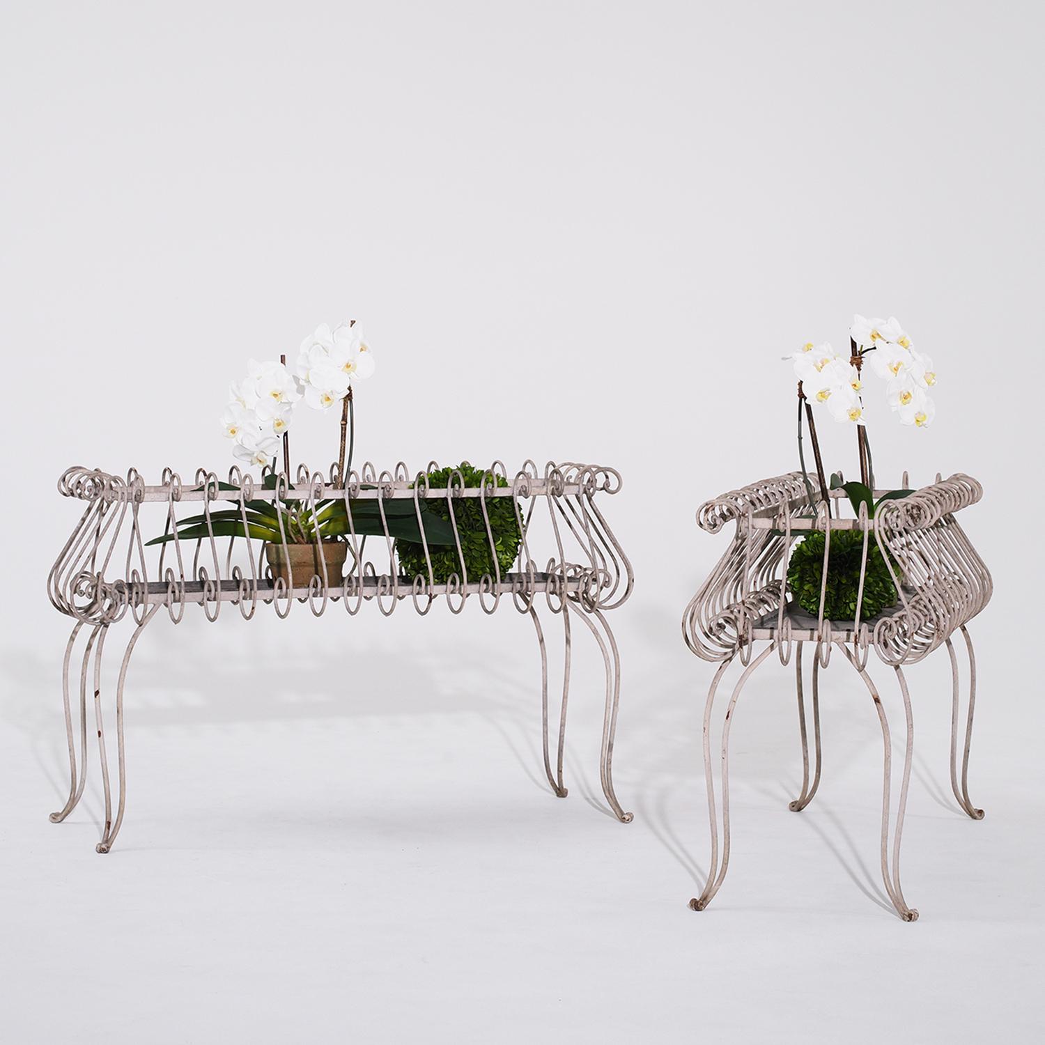 A vintage French pair of rectangular white metal plant stands adorned with a continuous scroll pattern, in good condition. Natural aged patina adds to the charm of these jardinieres. Minor fading, scratches due to age. Wear consistent with age and