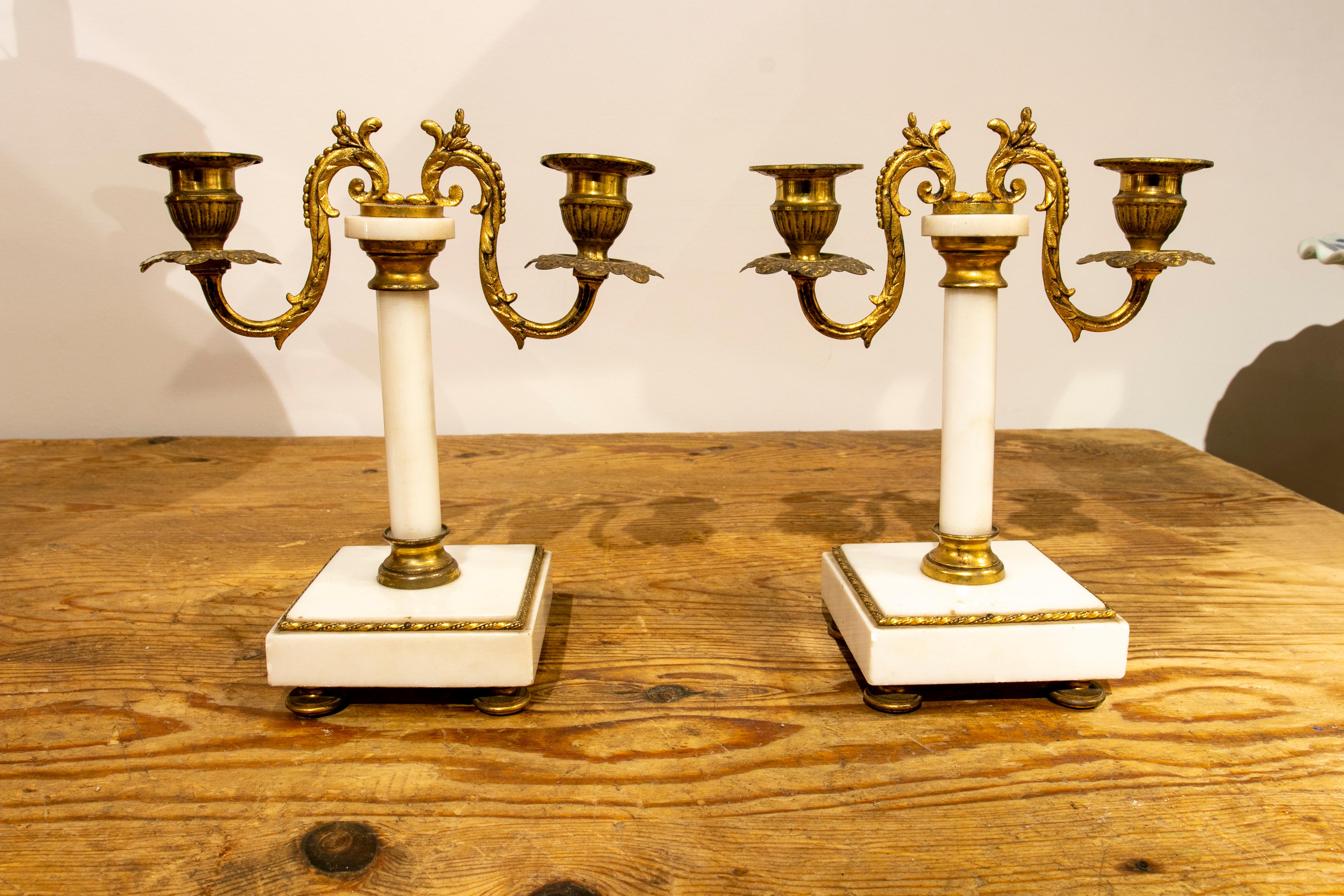 Coppia di candelieri in marmo bianco e bronzo dorato del XIX secolo.