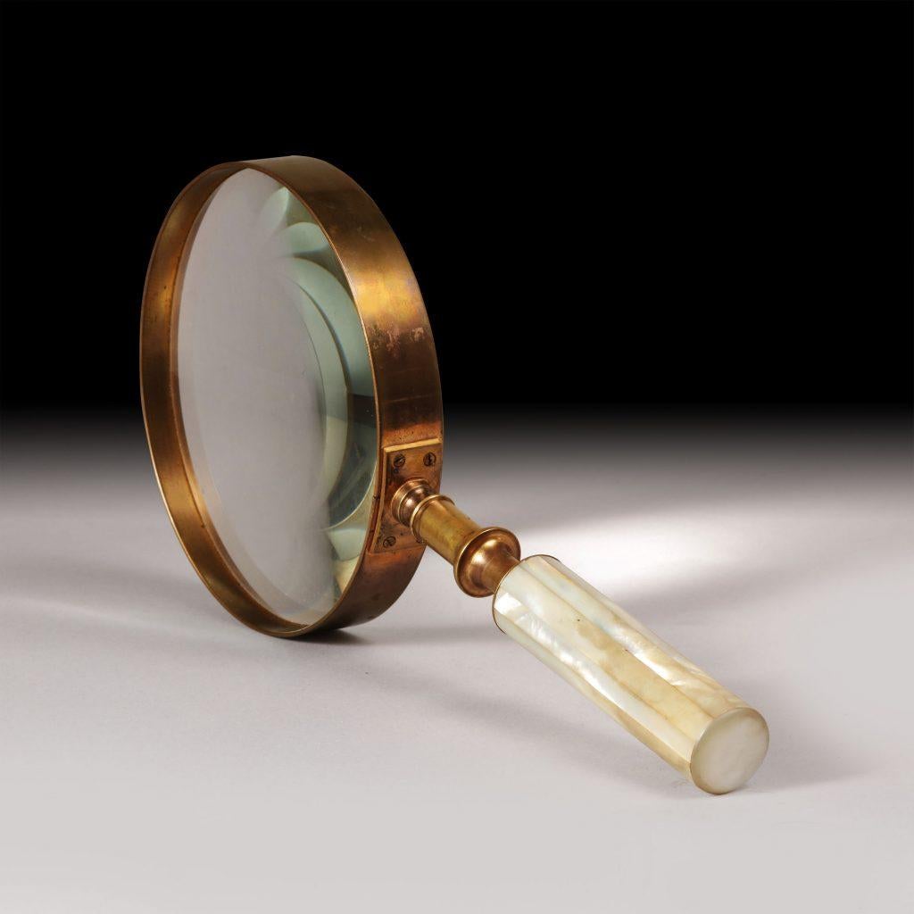 A large scale brass mounted gallery glass with a mother of pearl veneered handle.
Probably Palais Royal
France, circa 1840

Measure: Length 12 inches.