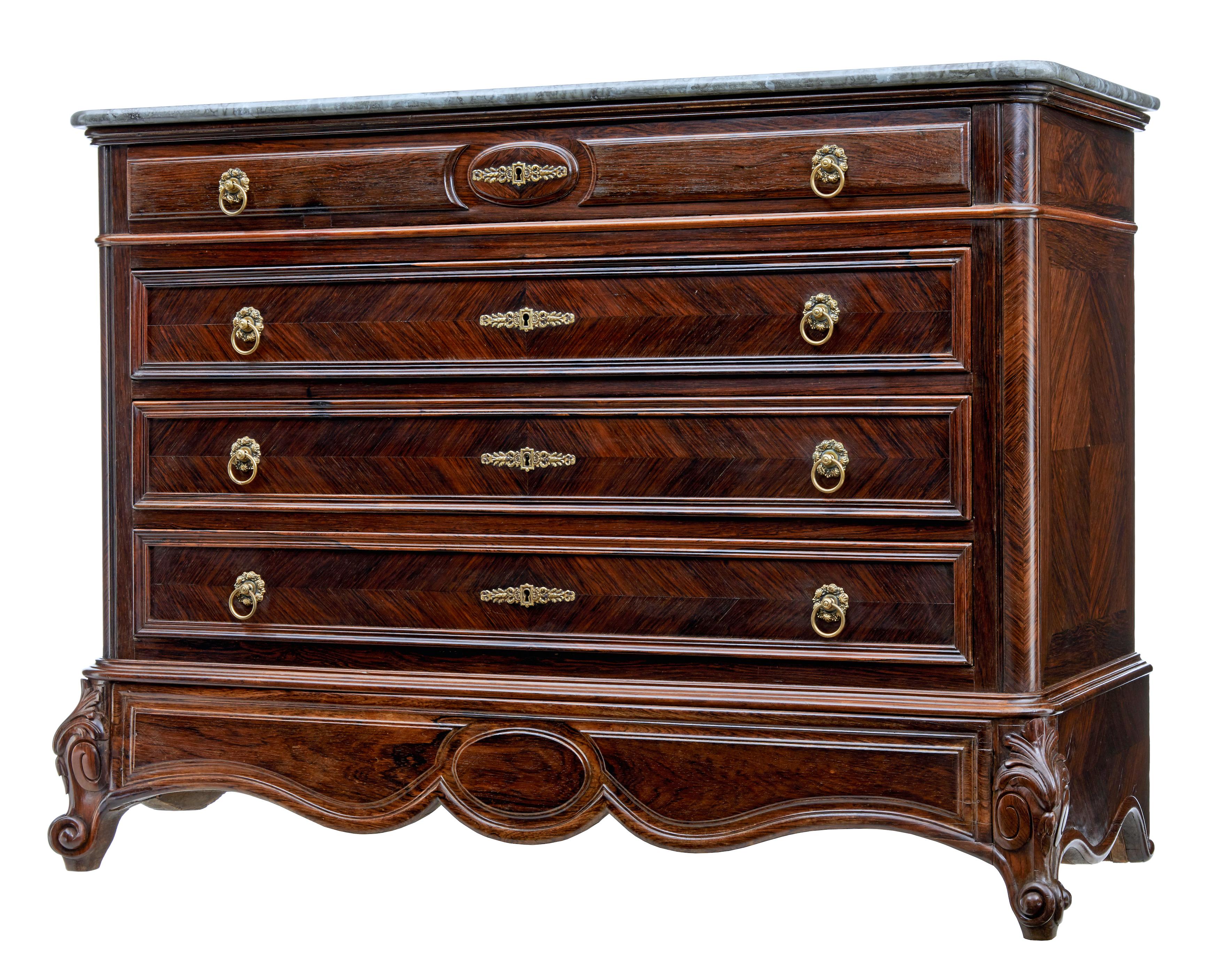 19th century French palisander chest of drawers with faux marble top circa 1870.

Stunning french commode of grand proportions beautifully veneered in palisander from the rosewood family.

Fitted with 4 drawer's of equal proportions, decorated with