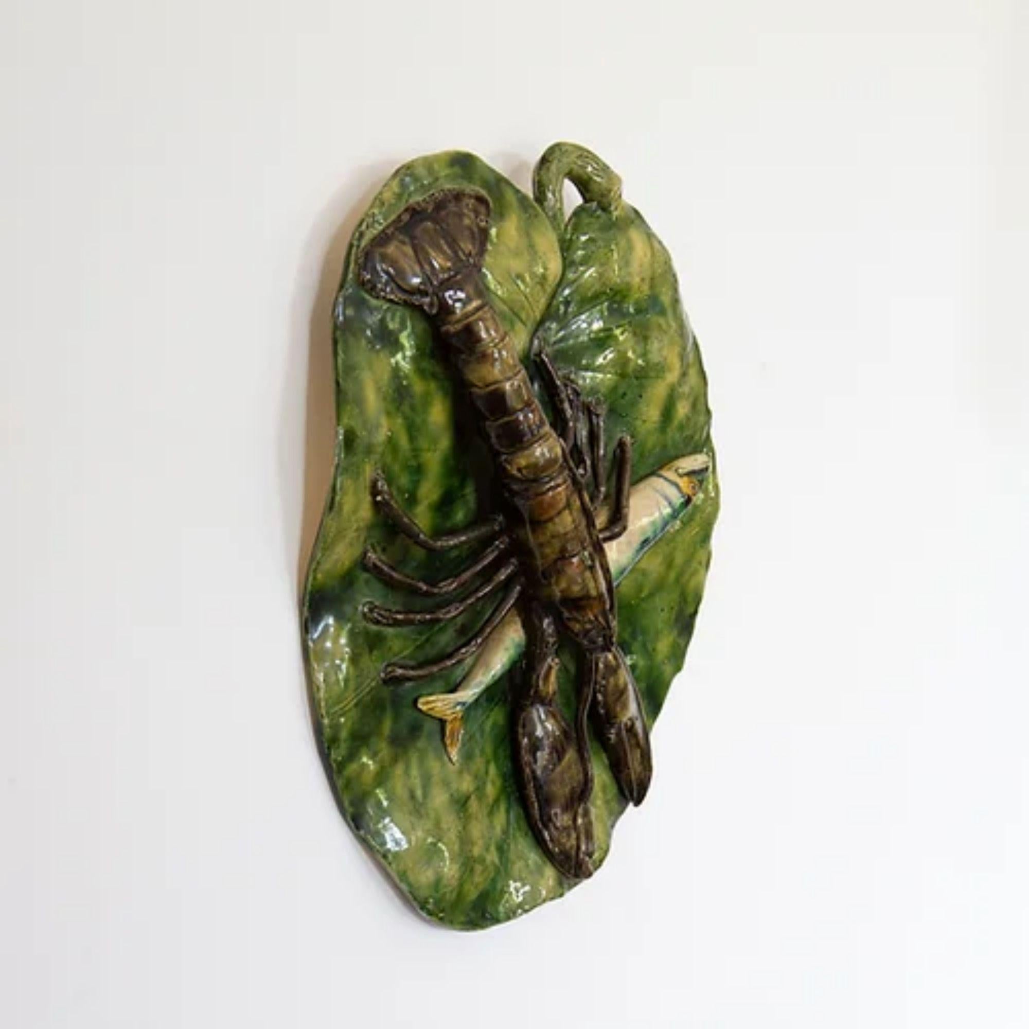 A 19th century Palissy Ware plaque featuring a fish and a langoustine on a leaf. Stamped Polakowski & Cie, Roumazieres to the underside and probably made by Alfred Renoleau, circa 1889-1891. 

Palissy Ware is a 19th century term for ceramics
