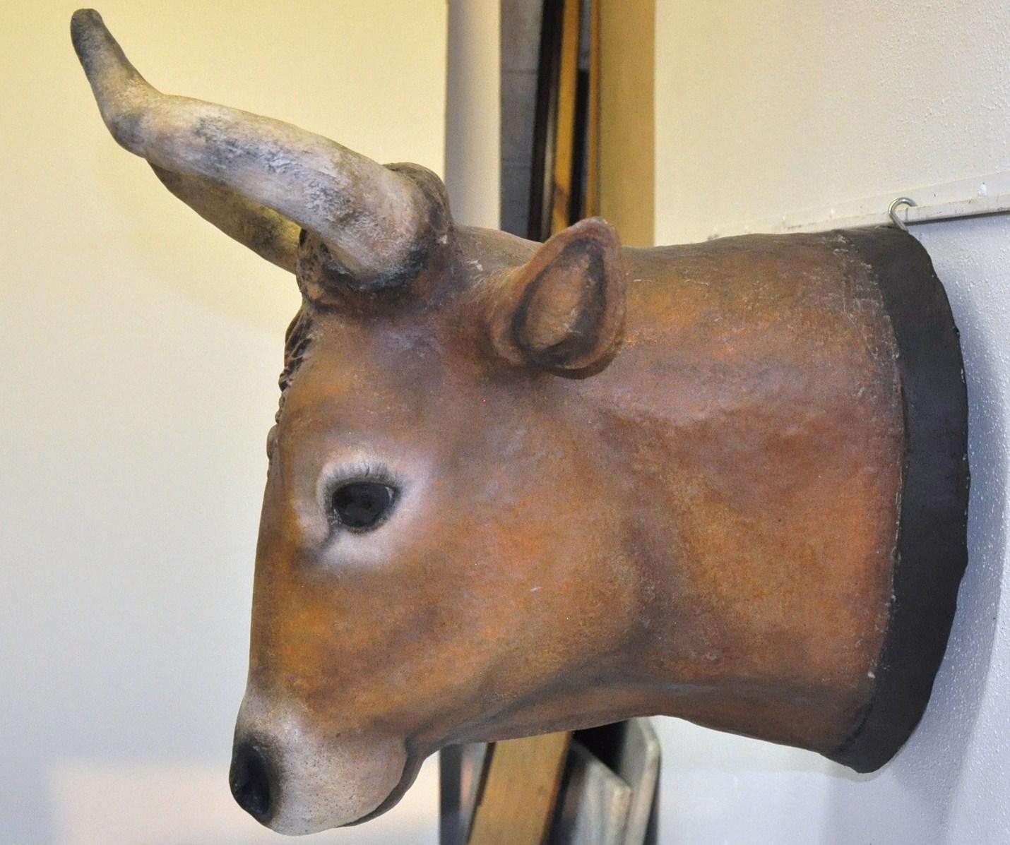 Decorate your kitchen with this antique cow head. Crafted in northern France, circa 1890, the large handmade papier mâché head sculpture was found in a butcher shop in Normandy. The bovine animal head features its original painted finish in a