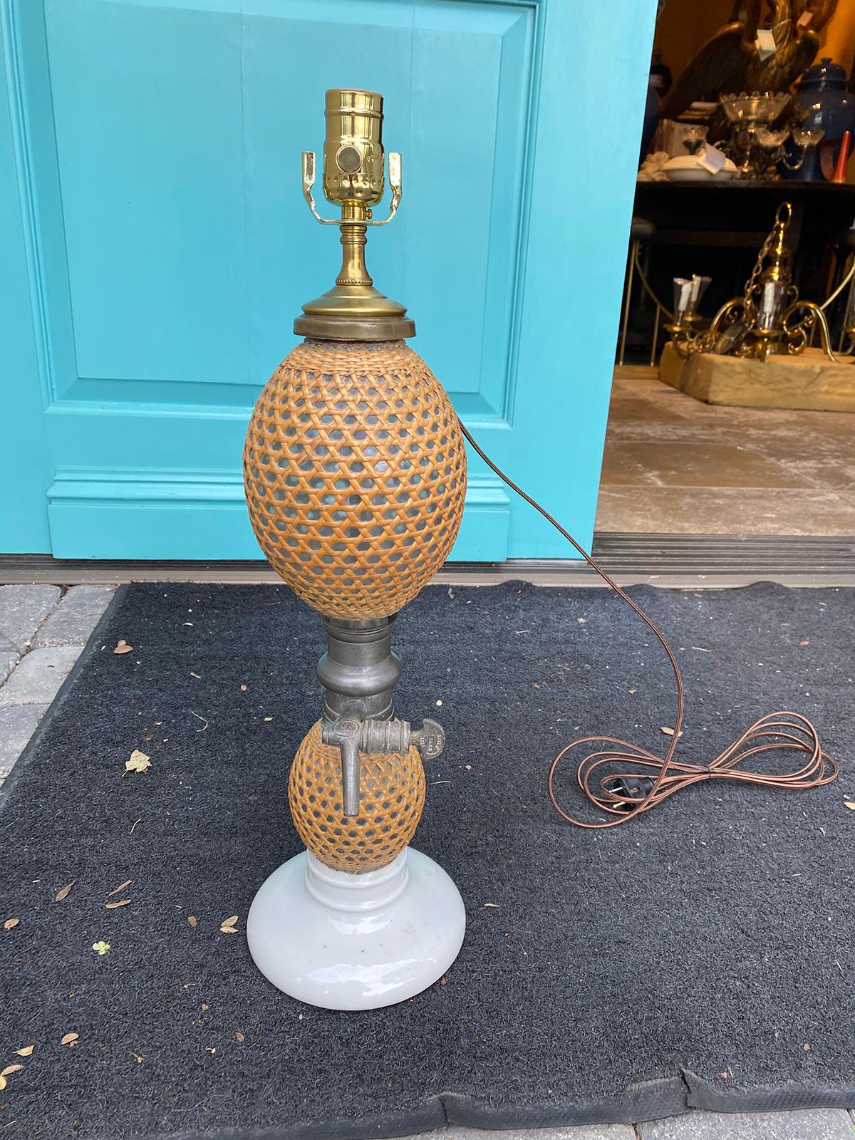 19th century circa 1840s-1880s French Paris Gazogene Briet Brevete rattan covered glass and pewter seltzer bottle as lamp on white porcelain base, marked.
New wiring.